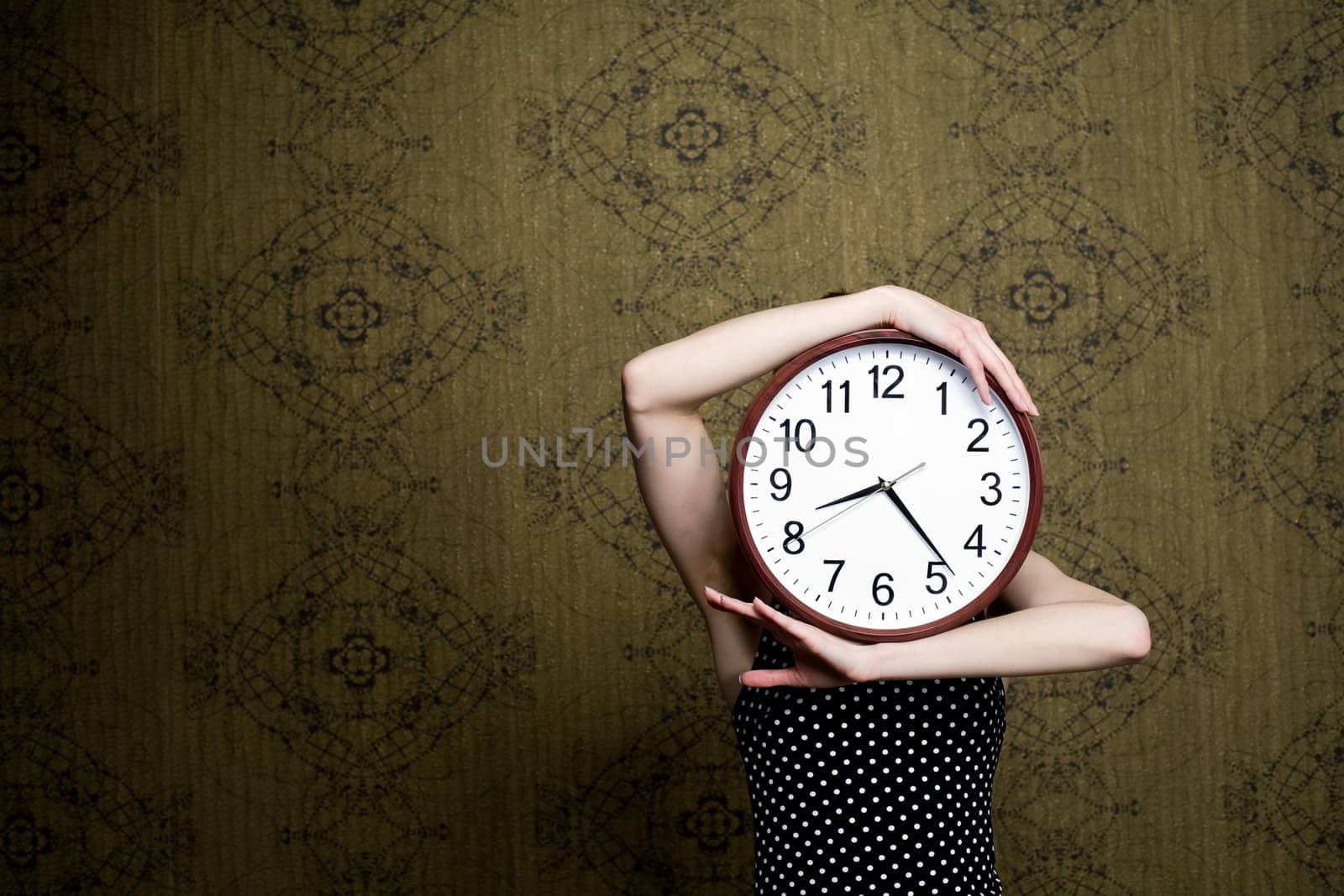 An image of a girl holding a big clock