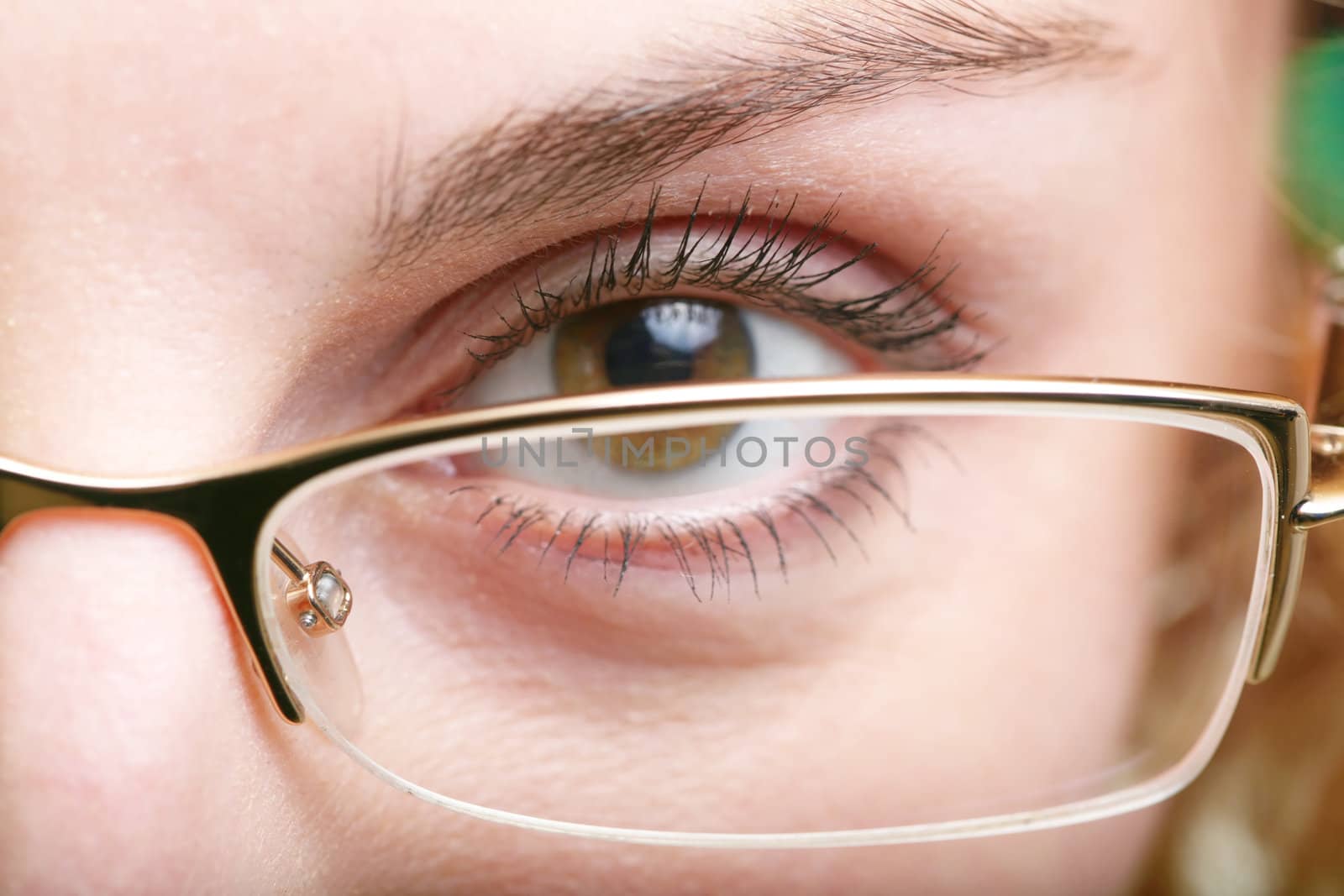 An image of a brown eye in glasses