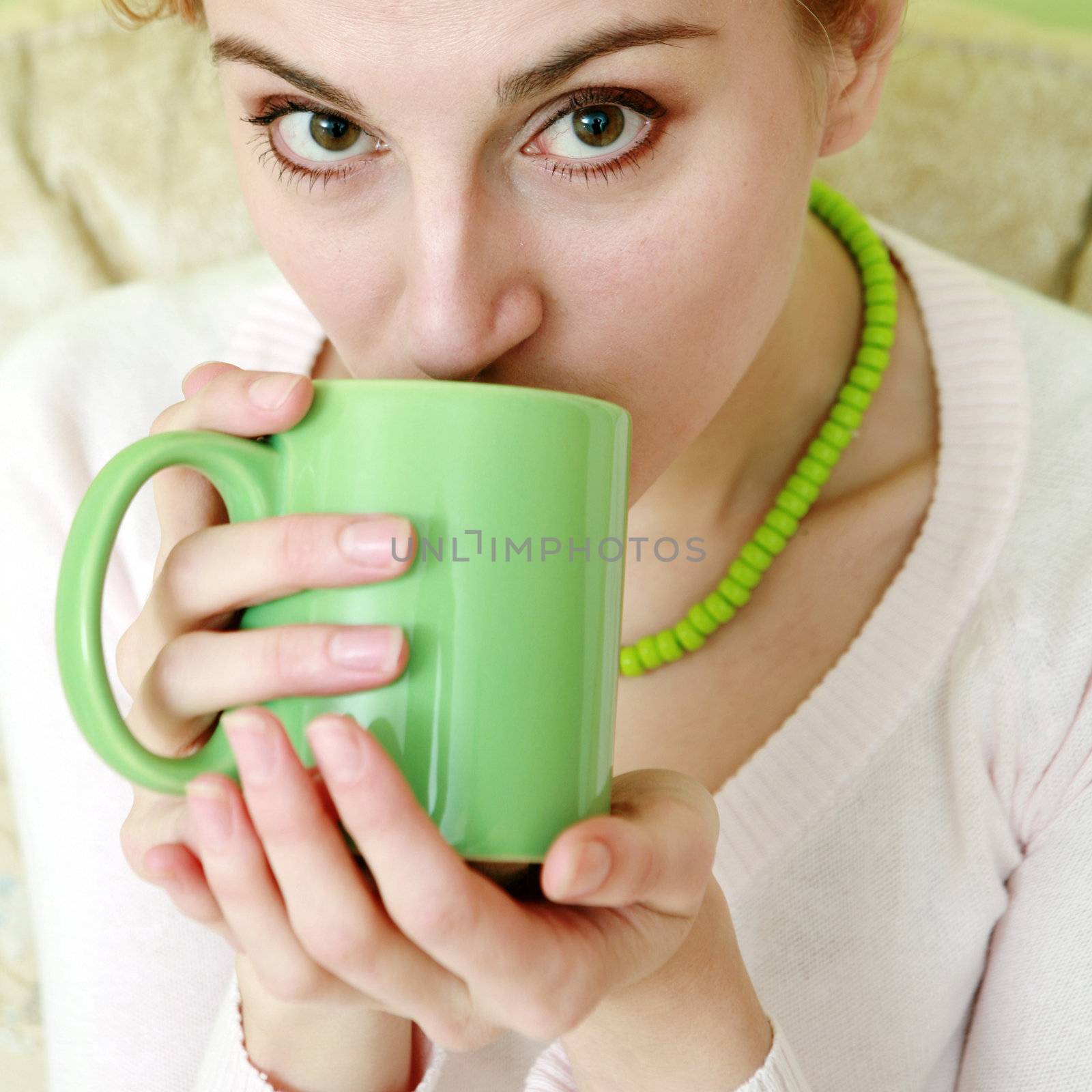 An image of a woman with green cup