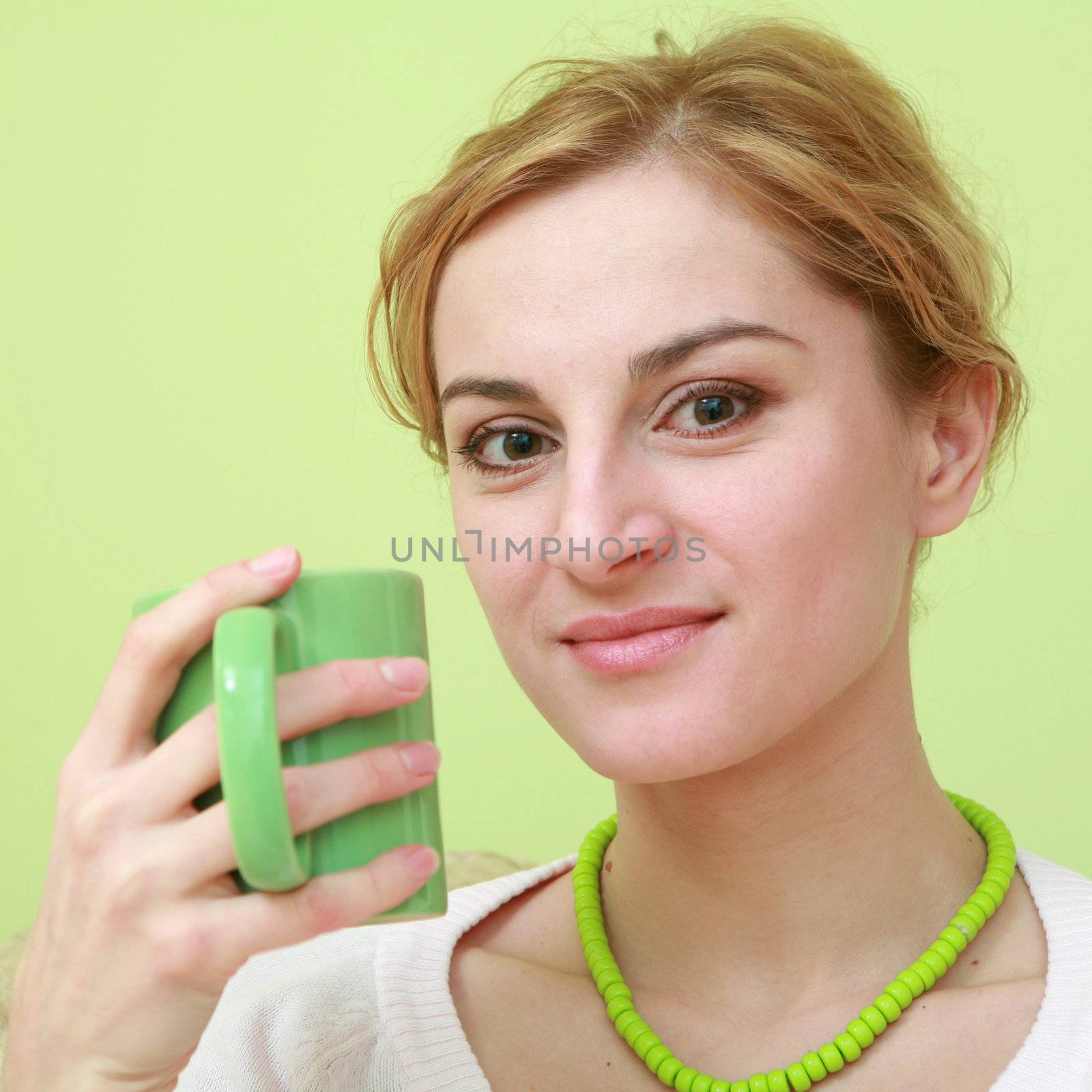 An image of a woman with green cup