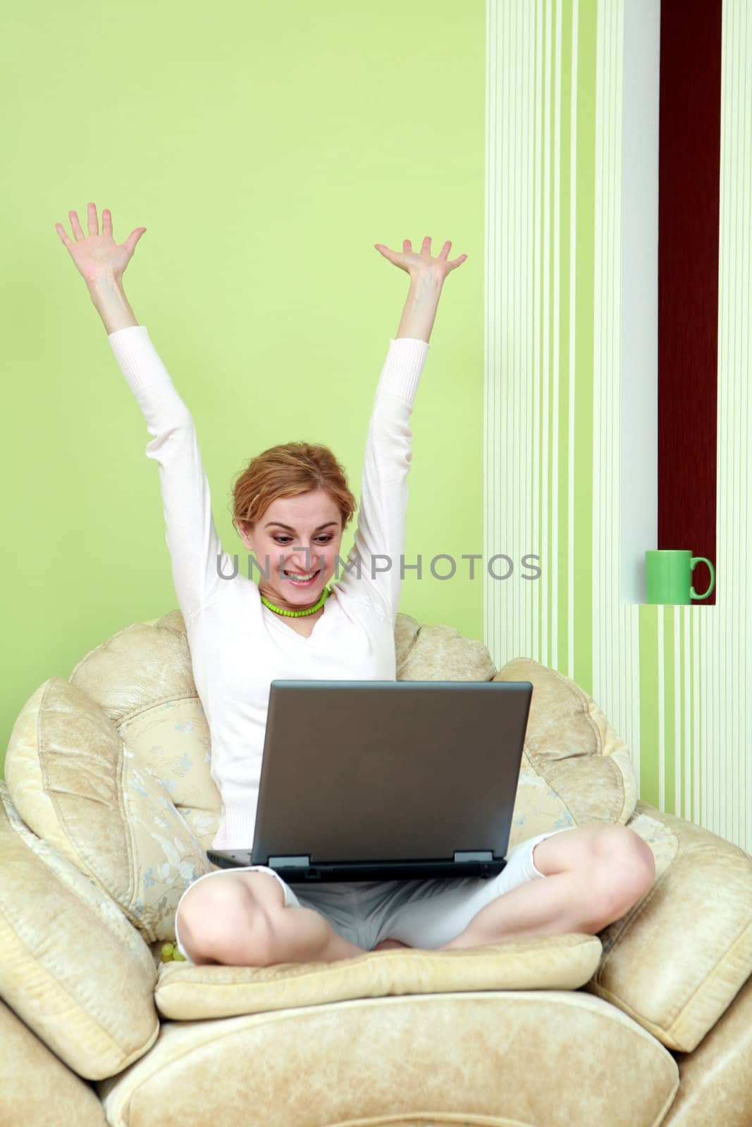 An image of young girl with a laptop at home