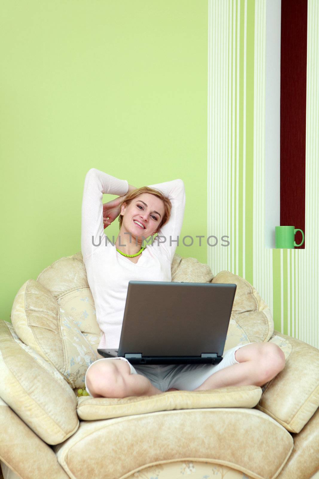 An image of a girl with a laptop at home