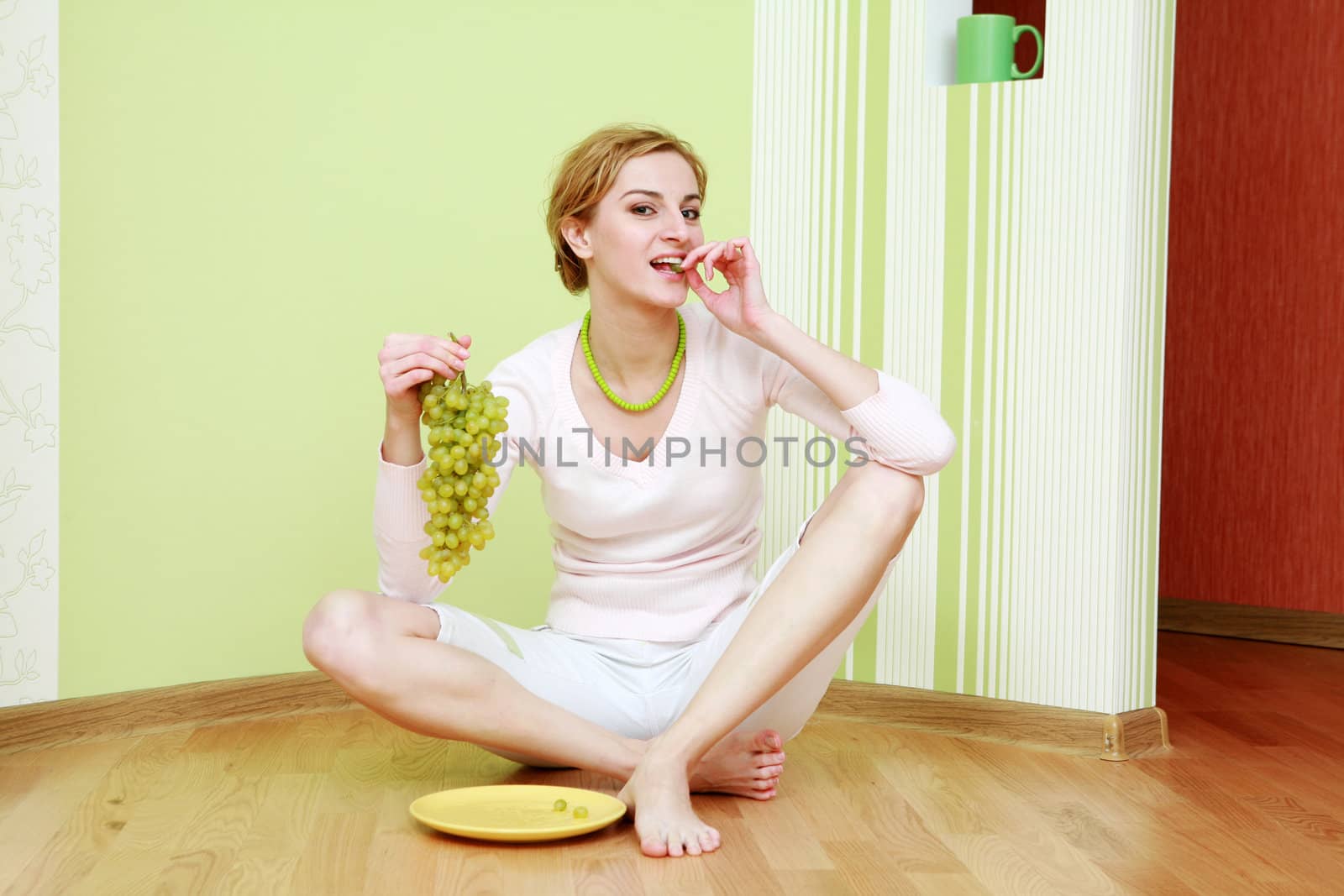 An image of slim girl with a bunch of grapes