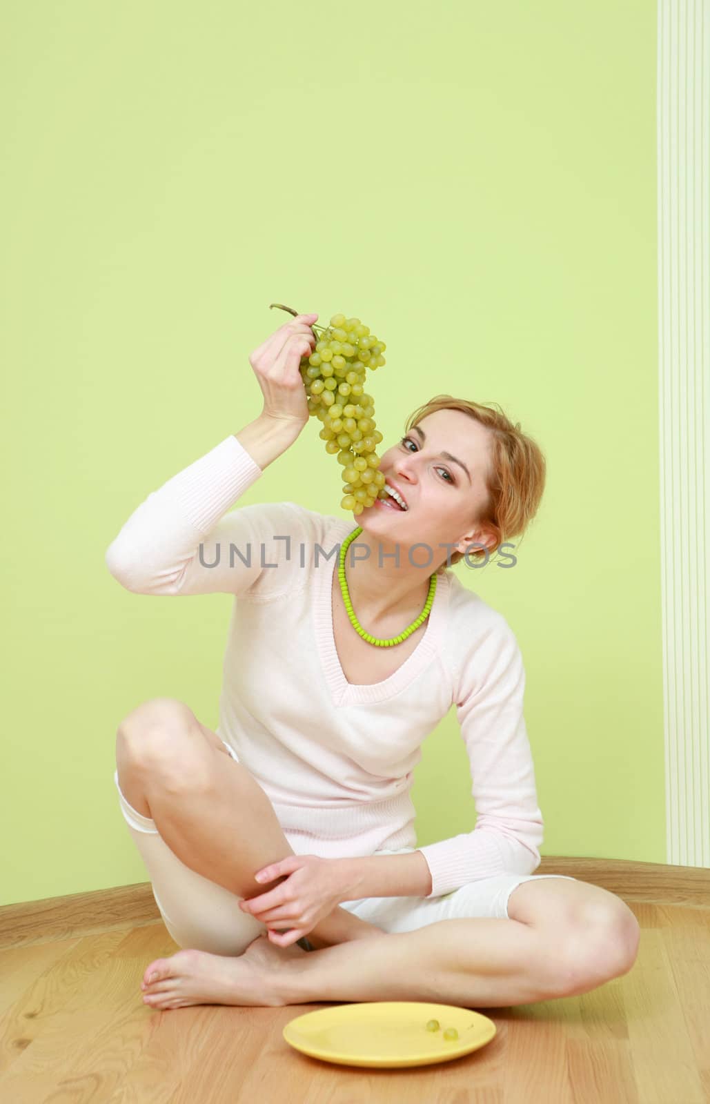 An image of a girl with a bunch of grapes