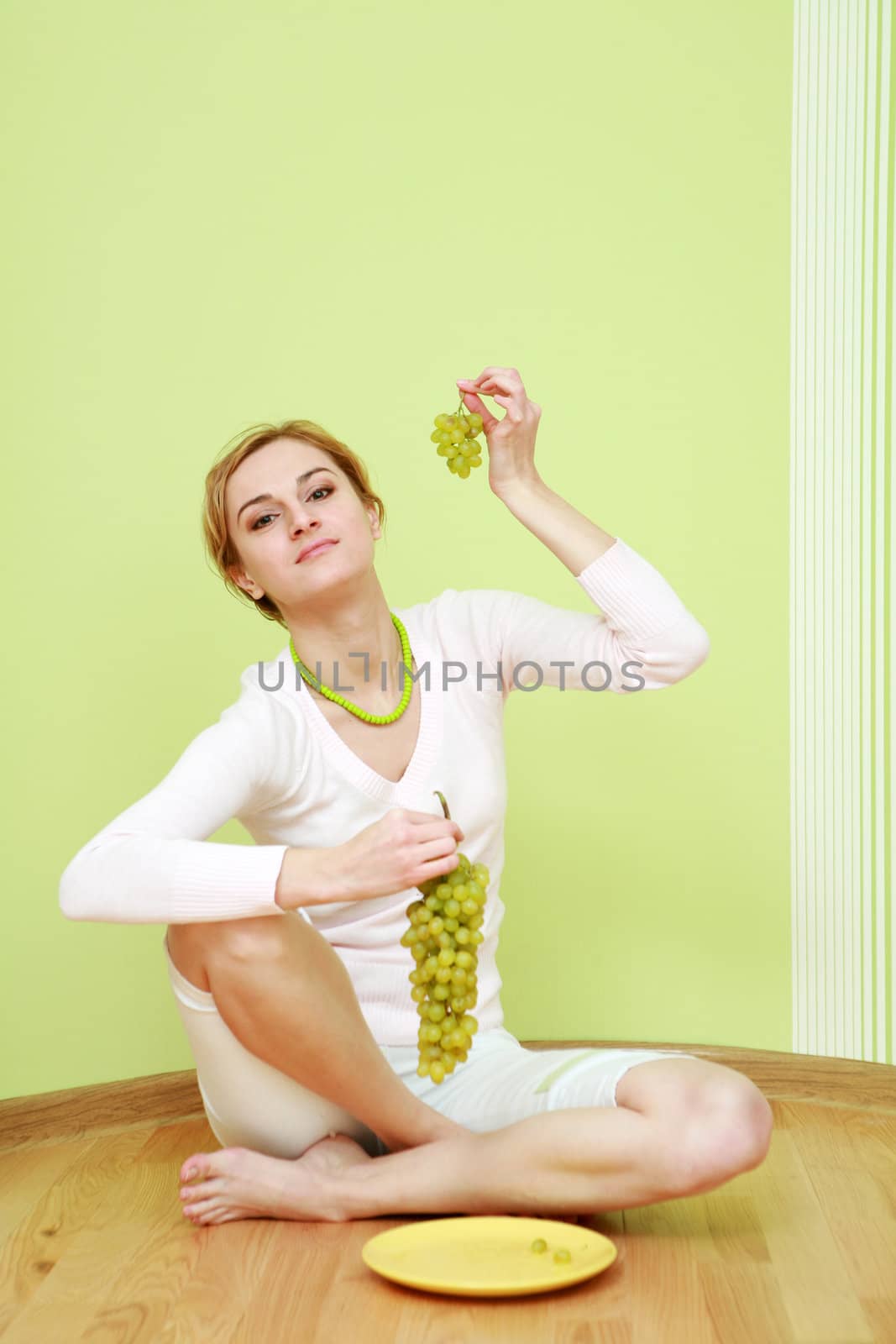 An image of a girl with a bunch of grapes