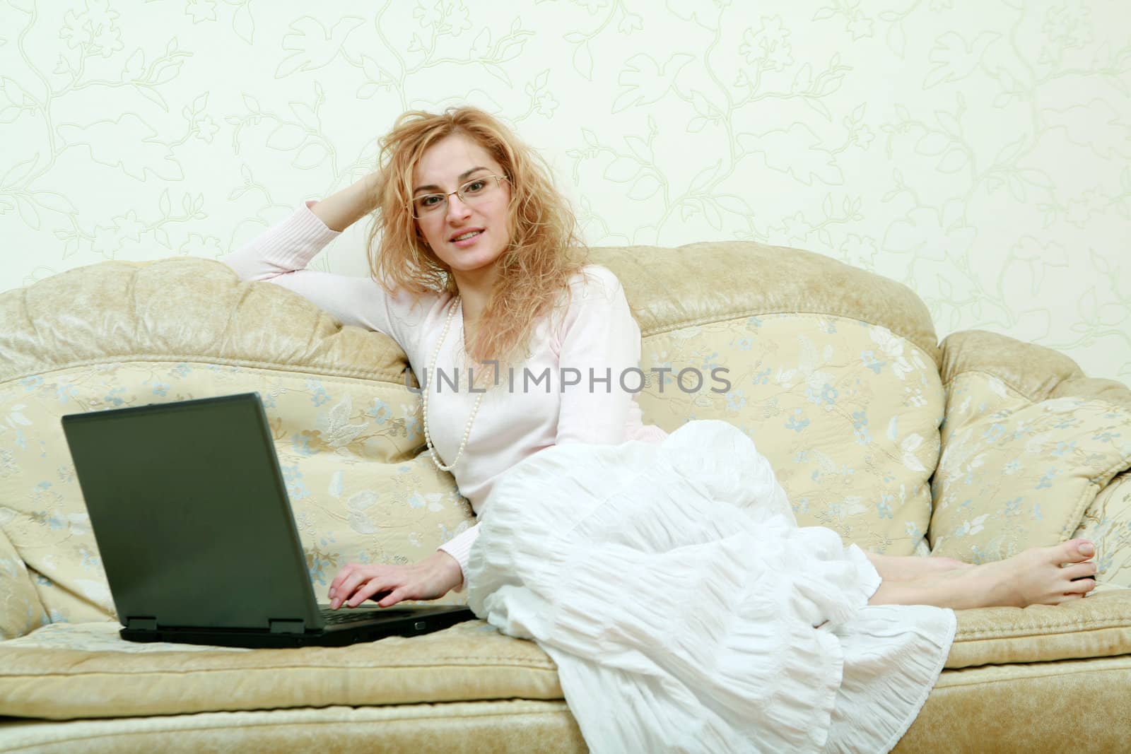 An image of a girl in glasses with laptop 
