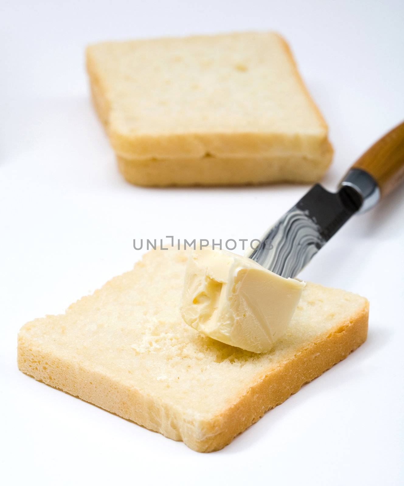 Stock photo: an image of butter on bread and a knife