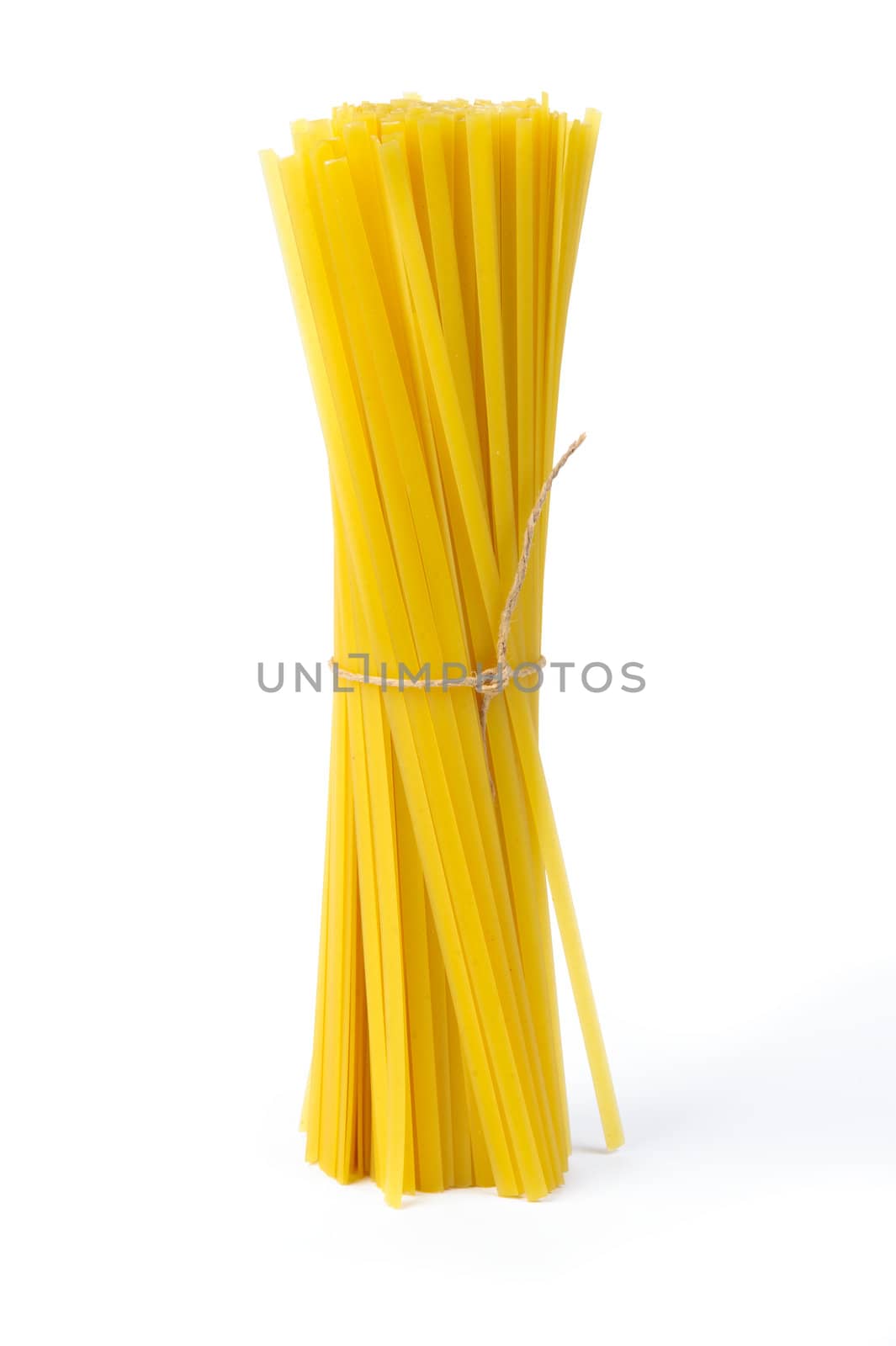 An image of raw yellow pasta on white background