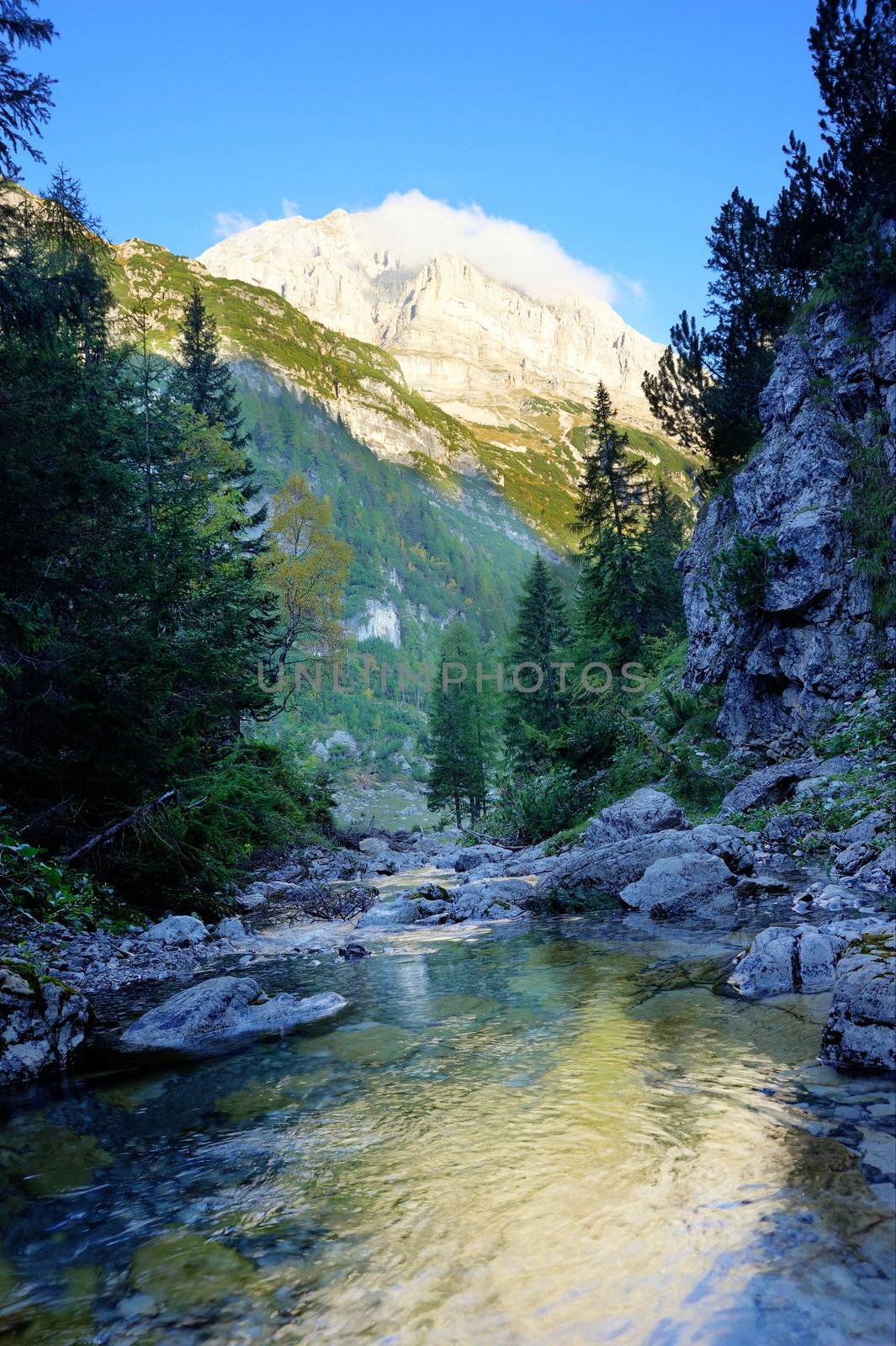 An image of majetic mountains and a river