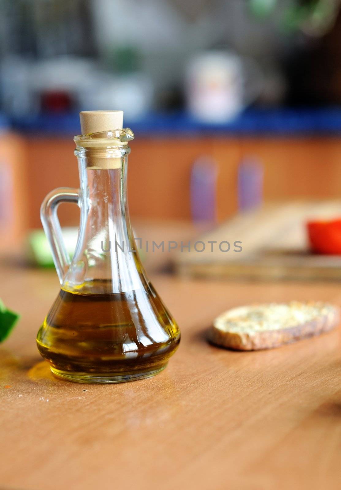 An image of a bottle of olive oil on the table