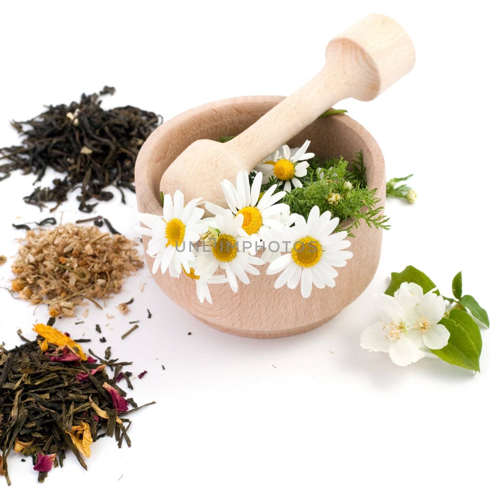 An image of wooden mortar with flowers in it and tea