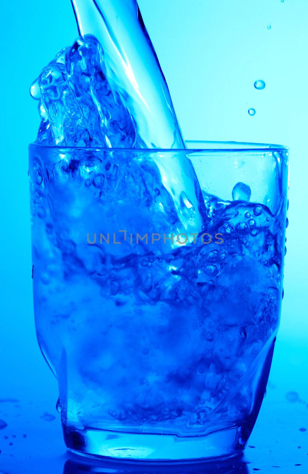 Drink theme: image of water splash in blue glass