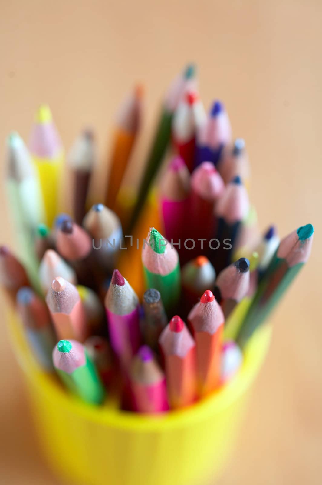 An image of  colored pencils in a plastic glass