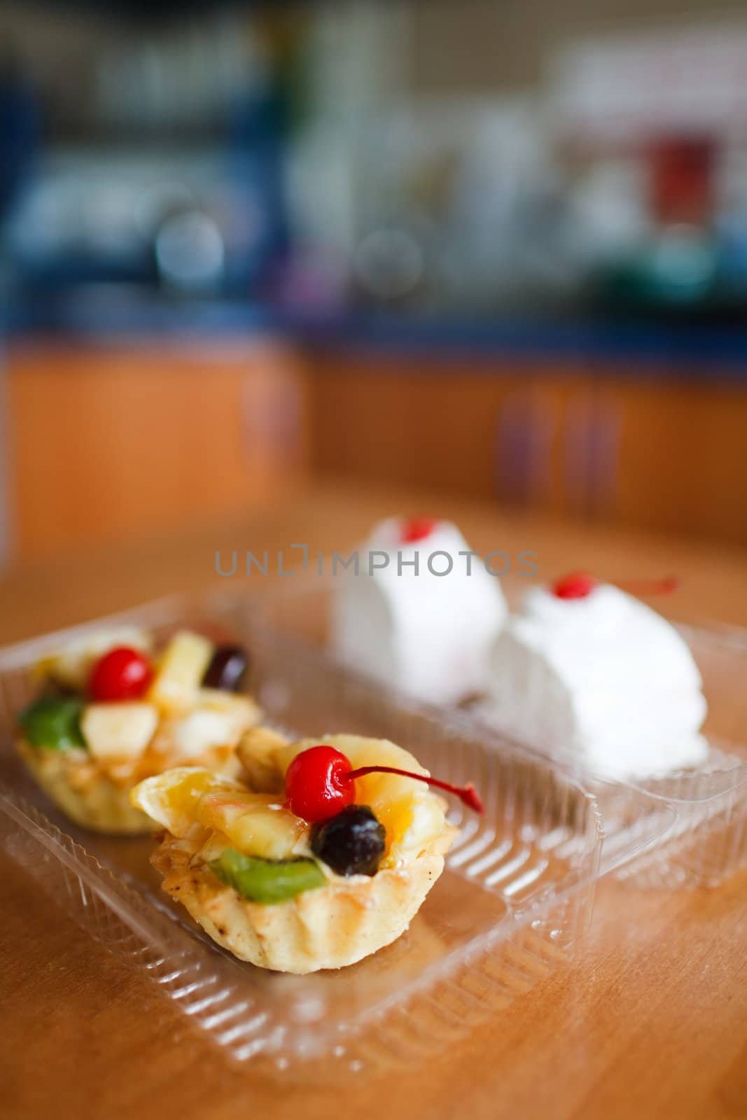 Cupcakes with cherry on top on wooden table. Selective focus. Make with Canon 35 1.4
aperture 1.4 was used for small DOF