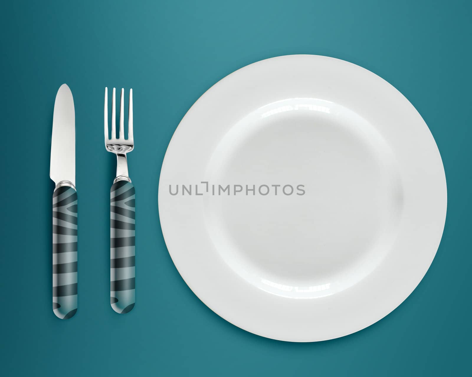empty white plate with knife and fork on blue background.