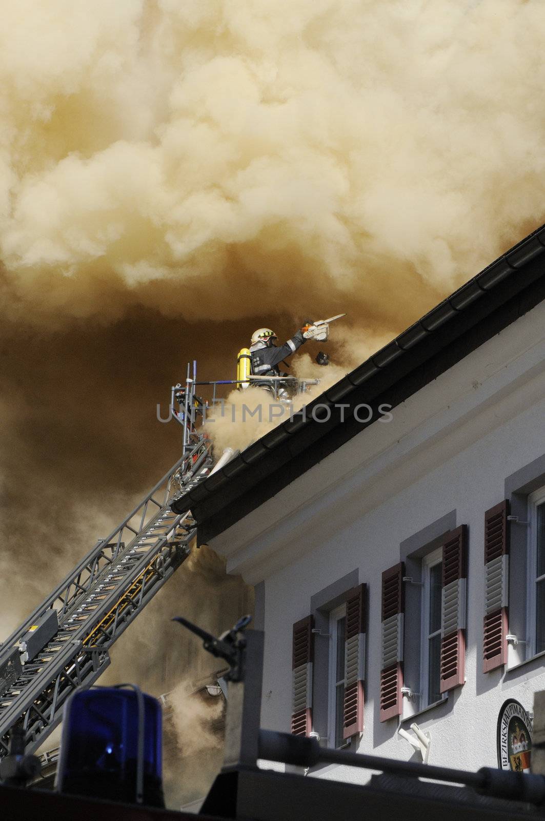 ZELL AM SEE; AUSTRIA - OCT 31: Firefighters attempt to extinguish a big fire in the centre of Zell am See on October 31, 2011 in Zell am See.