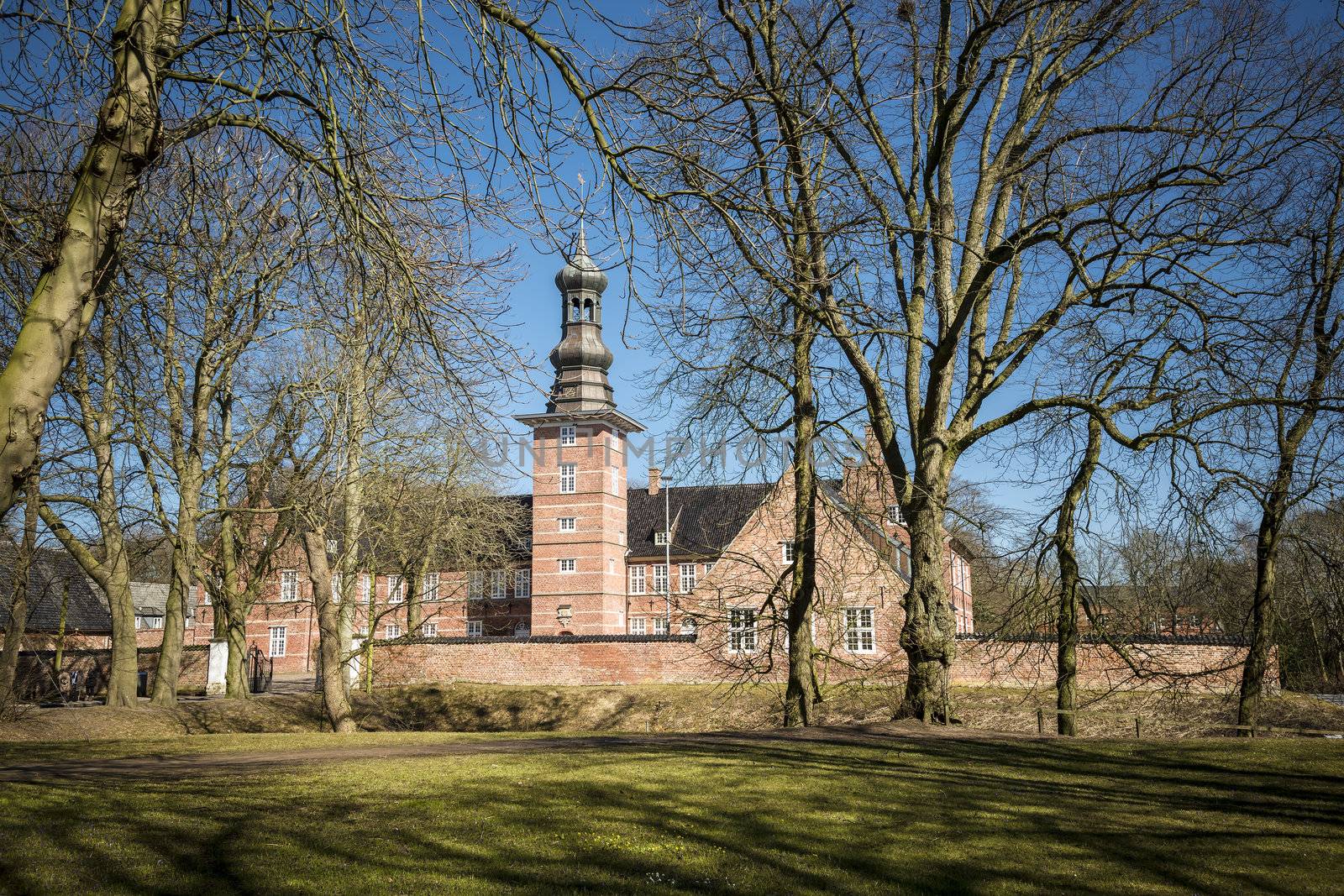 Caslte Husum with trees and blue sky on a sunny day in spring