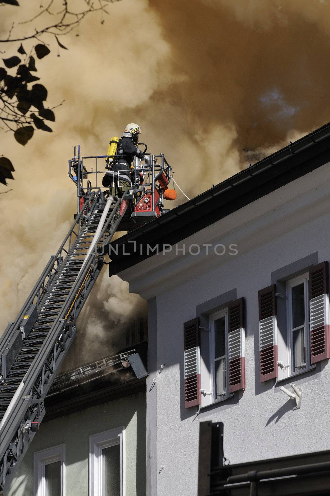 ZELL AM SEE; AUSTRIA - OCT 31: Firefighters attempt to extinguish a big fire in the centre of Zell am See on October 31, 2011 in Zell am See.