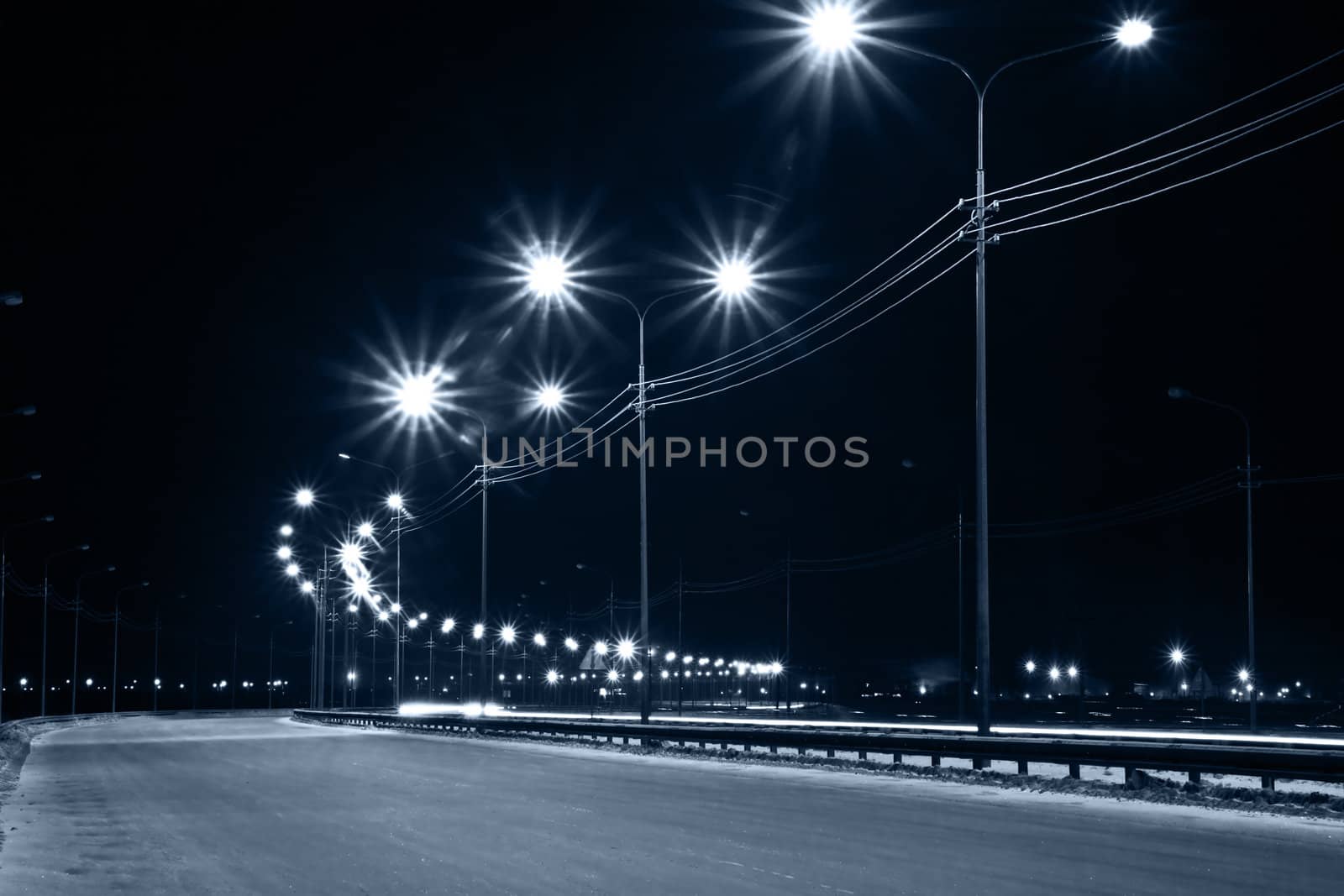 Night urban street with lights from lanterns