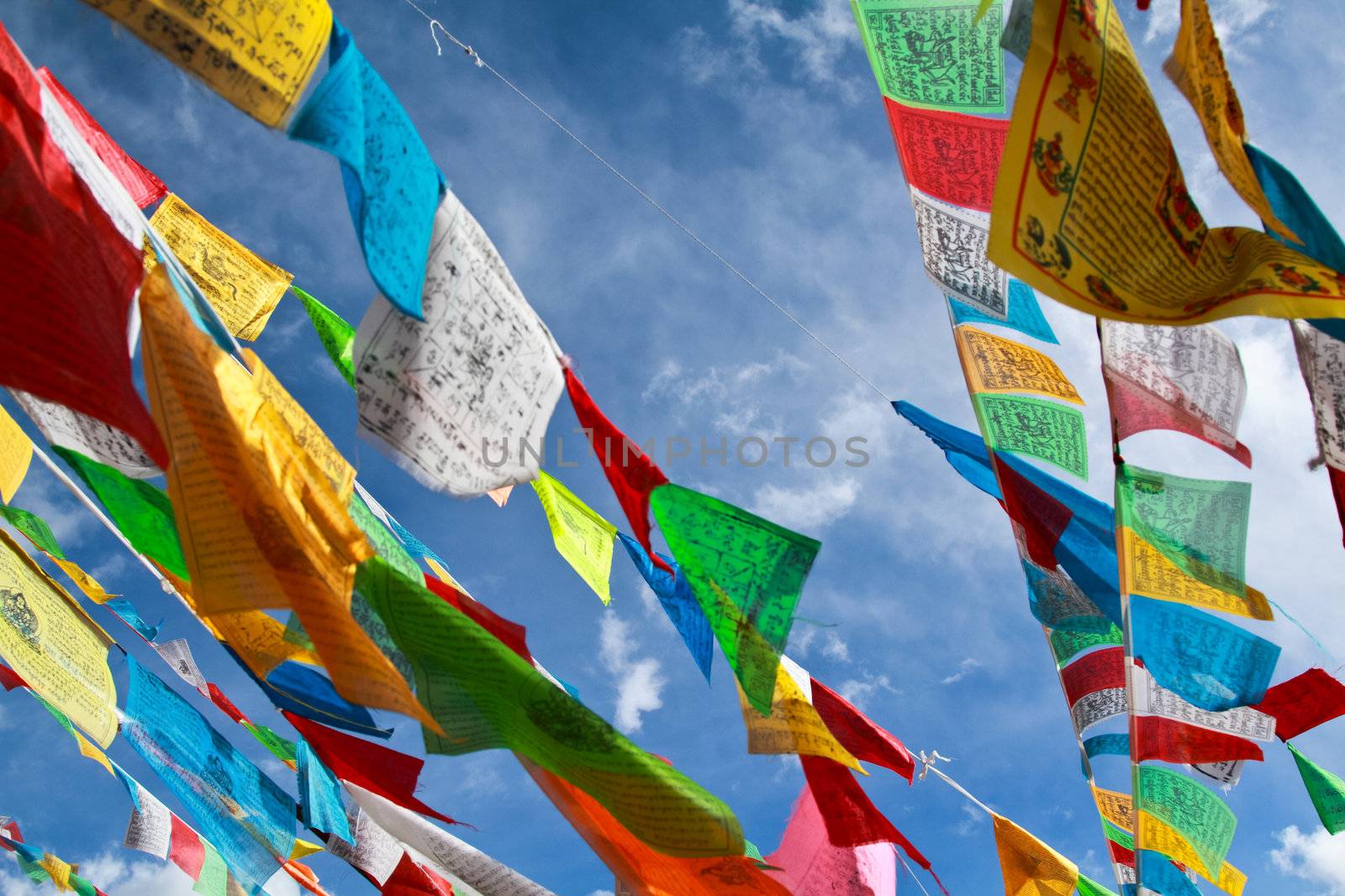 Buddhist tibetan prayer flags flying with blue sky
