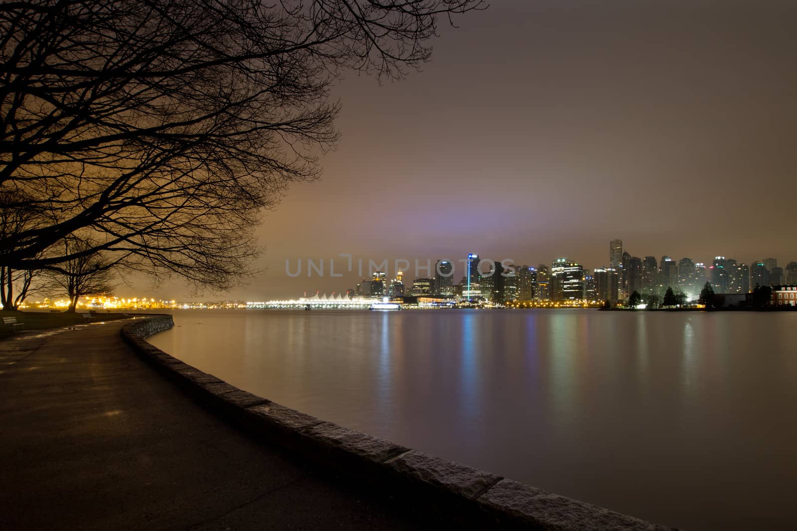 Vancouver BC Canada Stanley Park with City Skyline along Seawall at Dawn