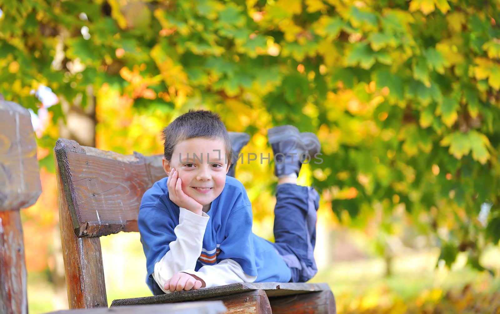 boy laying down on a bench