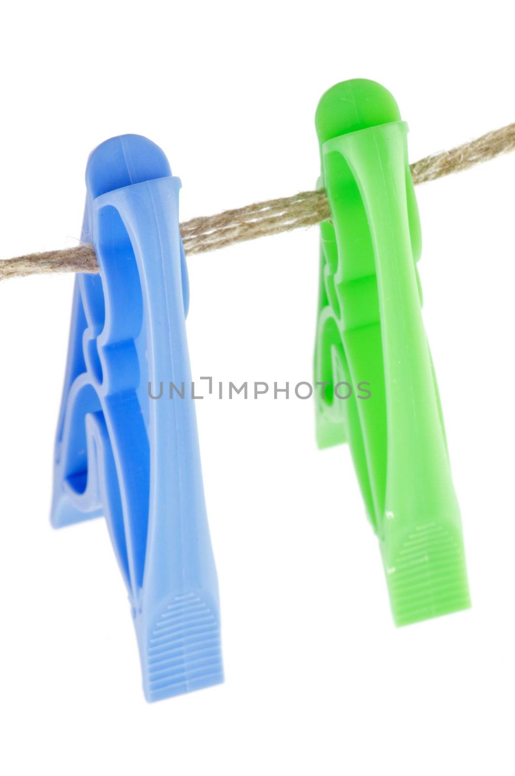 Two colour Clothespins on linen store isolated
