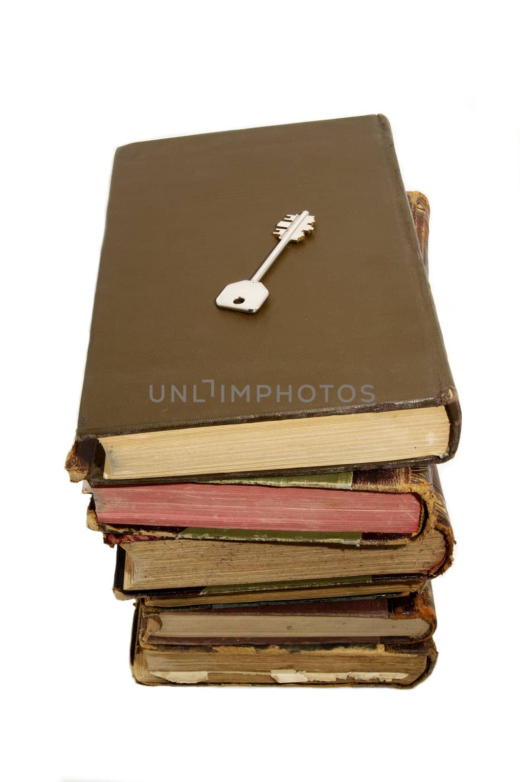 book and the key of knowledge on a white background