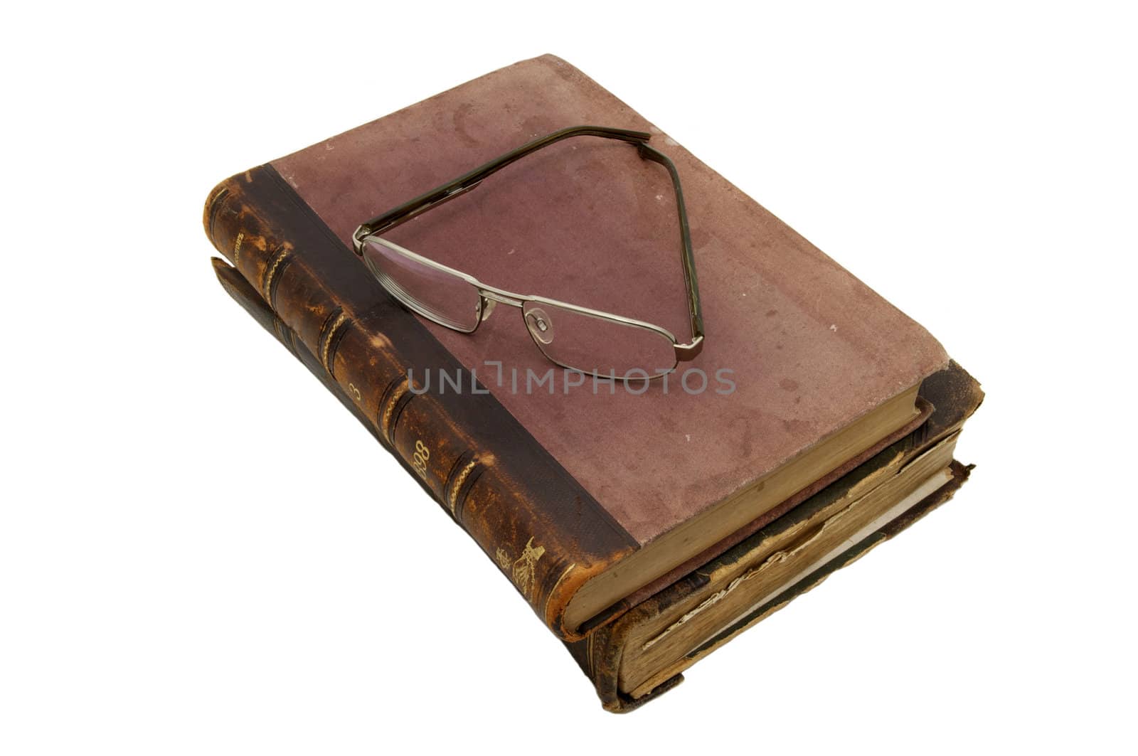 an old book and reading glasses on white background