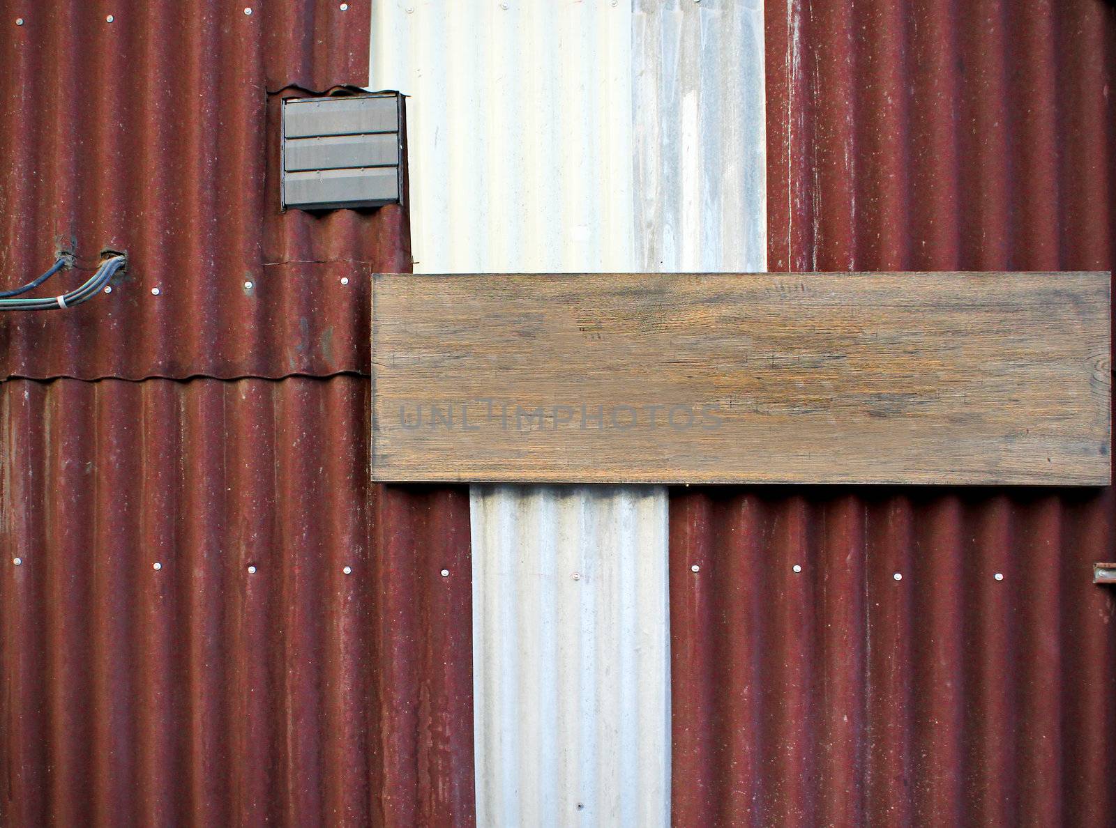 corrugated iron with empty wood board by nuchylee