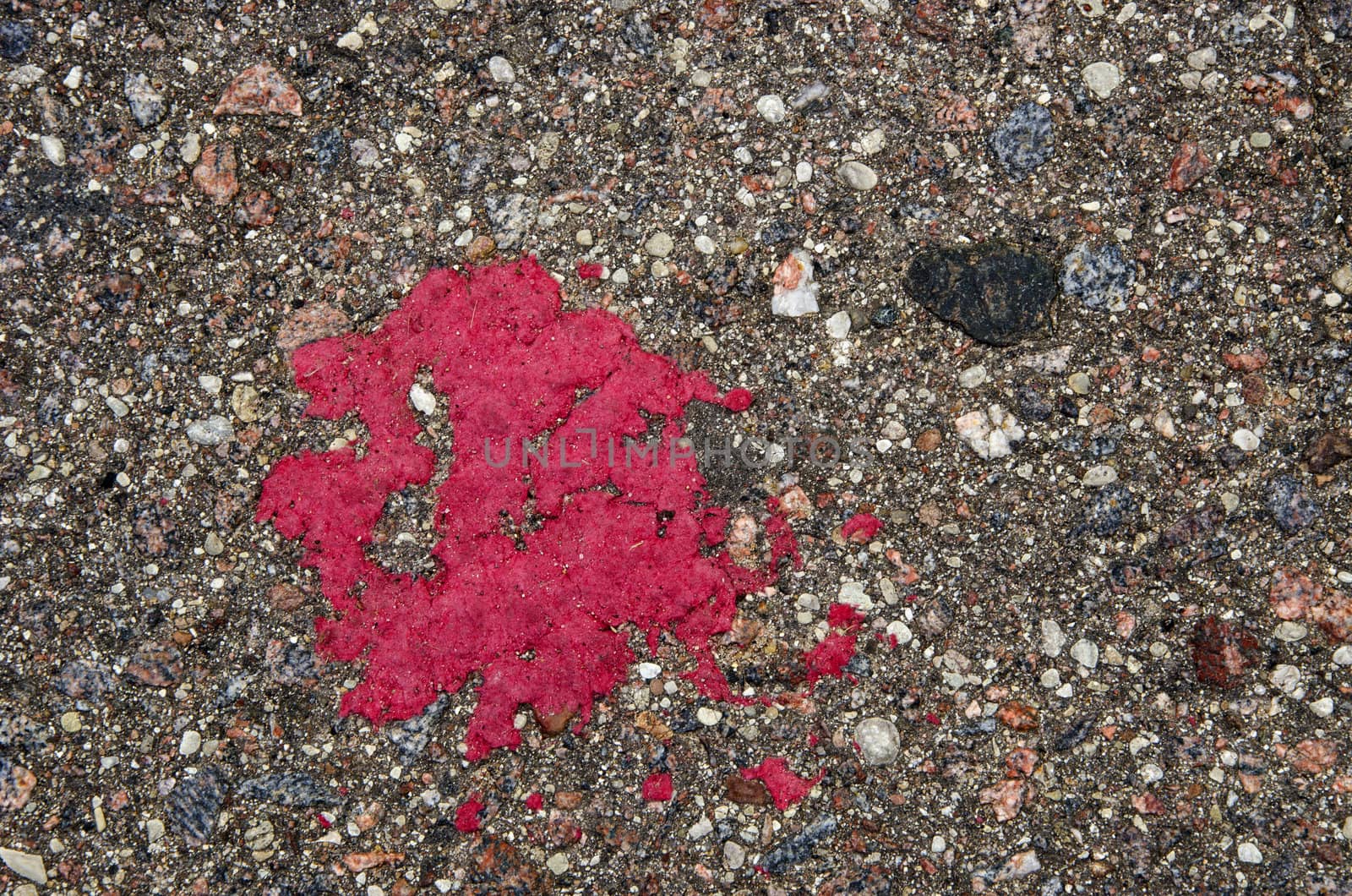 Background of grunge stone asphalt road closeup red paint stain.