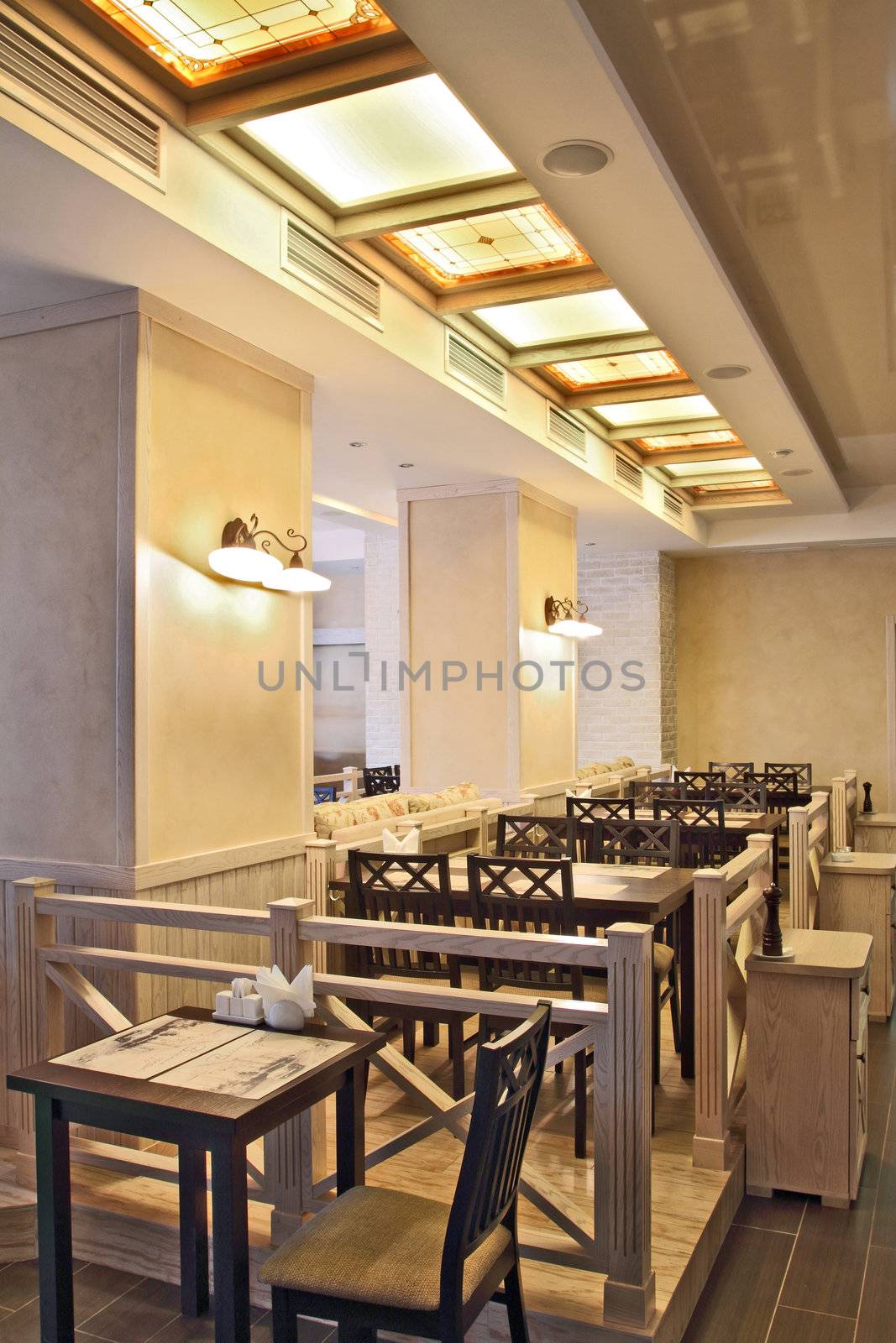 Interior of beautiful modern restaurant with a kind on a number of columns and fixtures, a vertical shot