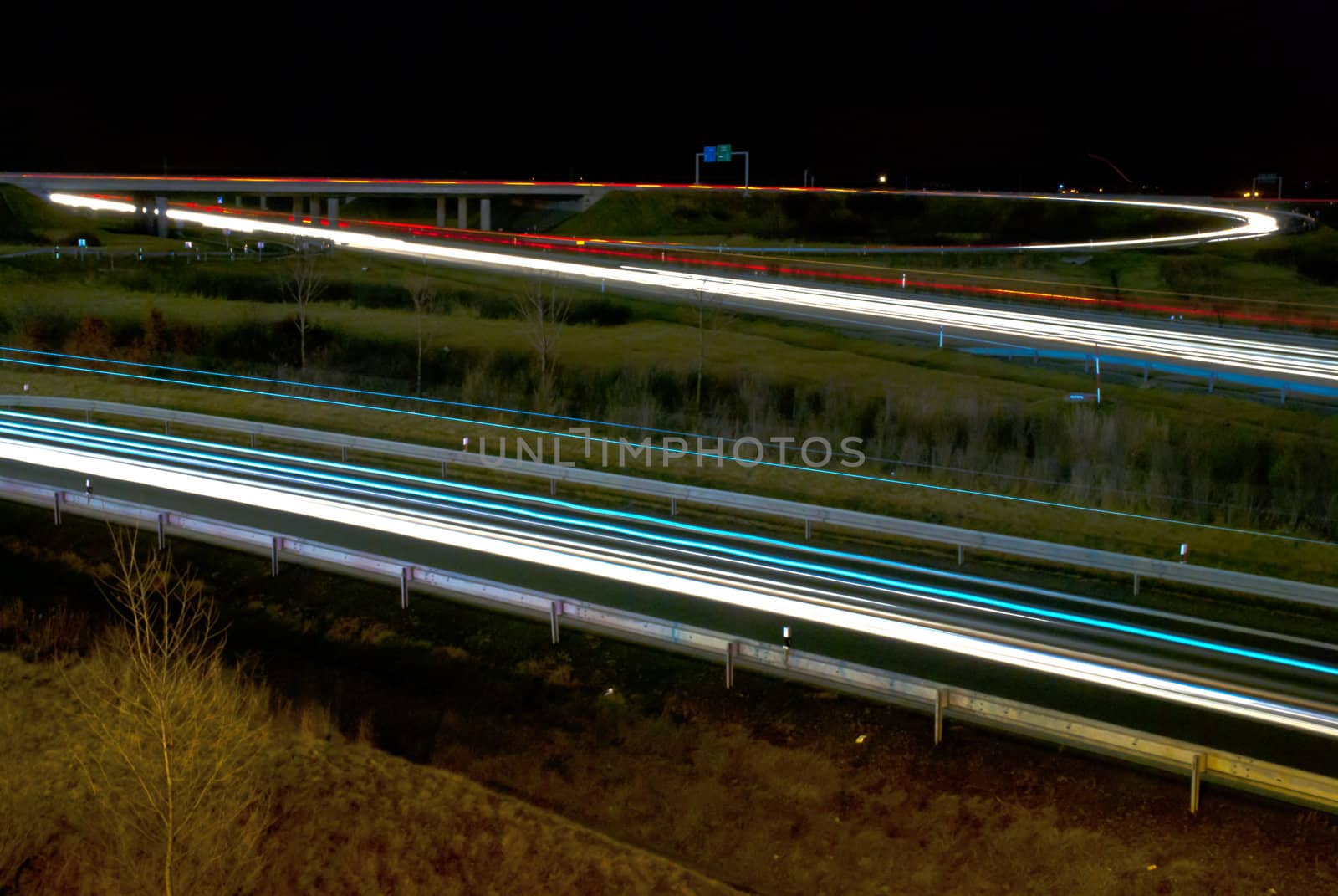 Blurred lights of cars on the highway. Night picture on motorway transportation.