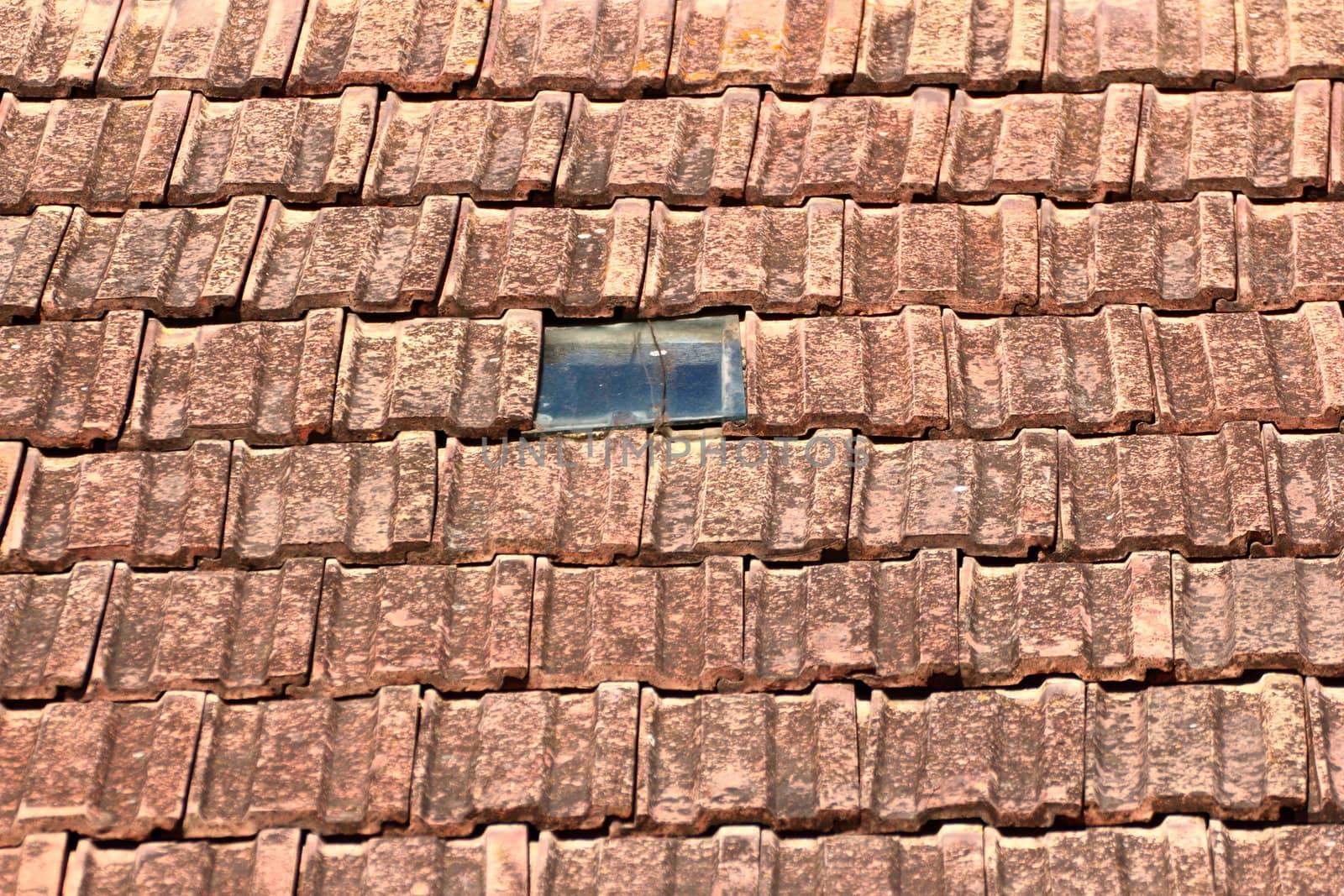 old tiles and little window for lighting the loft