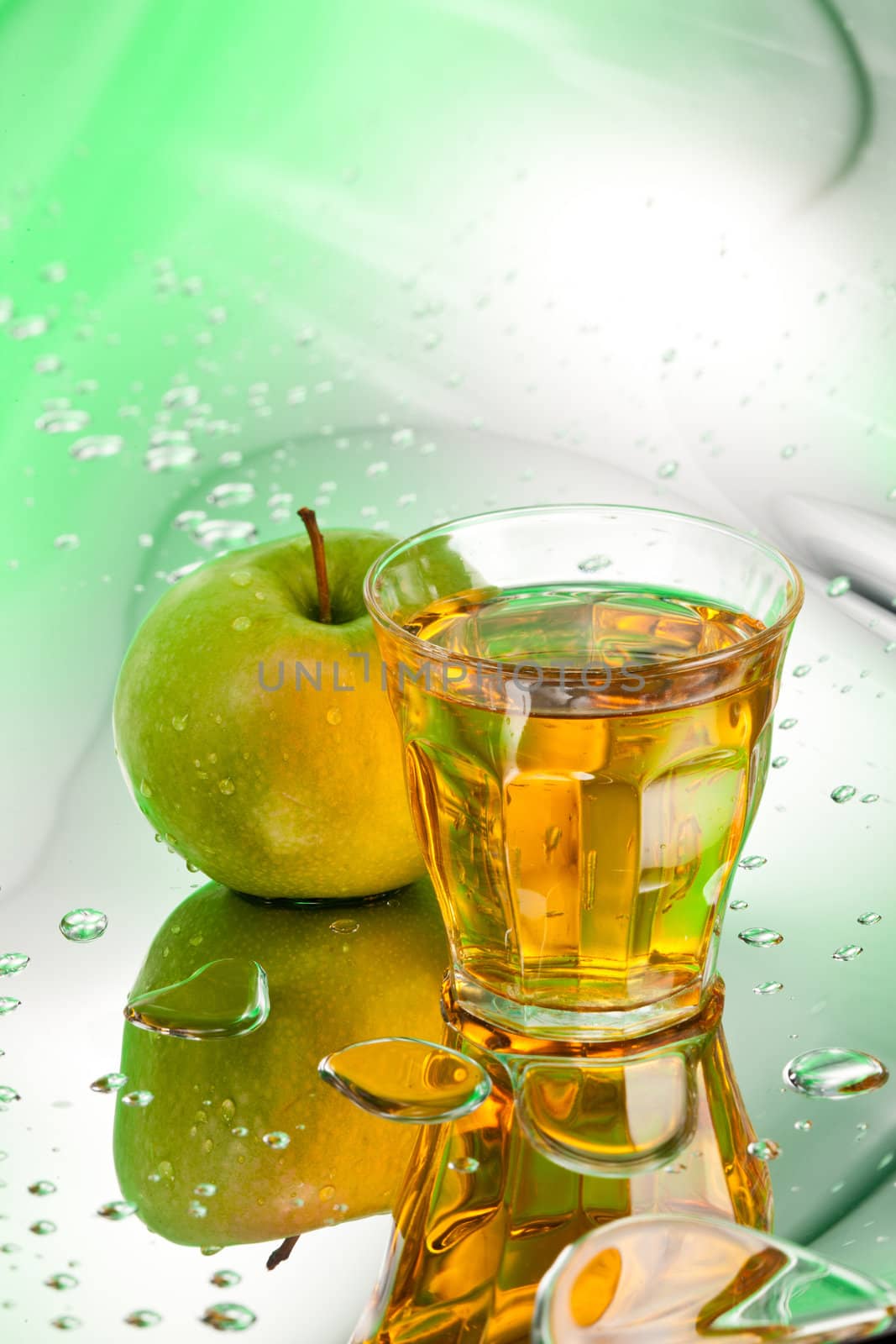 ripe apple and juice on abstract background