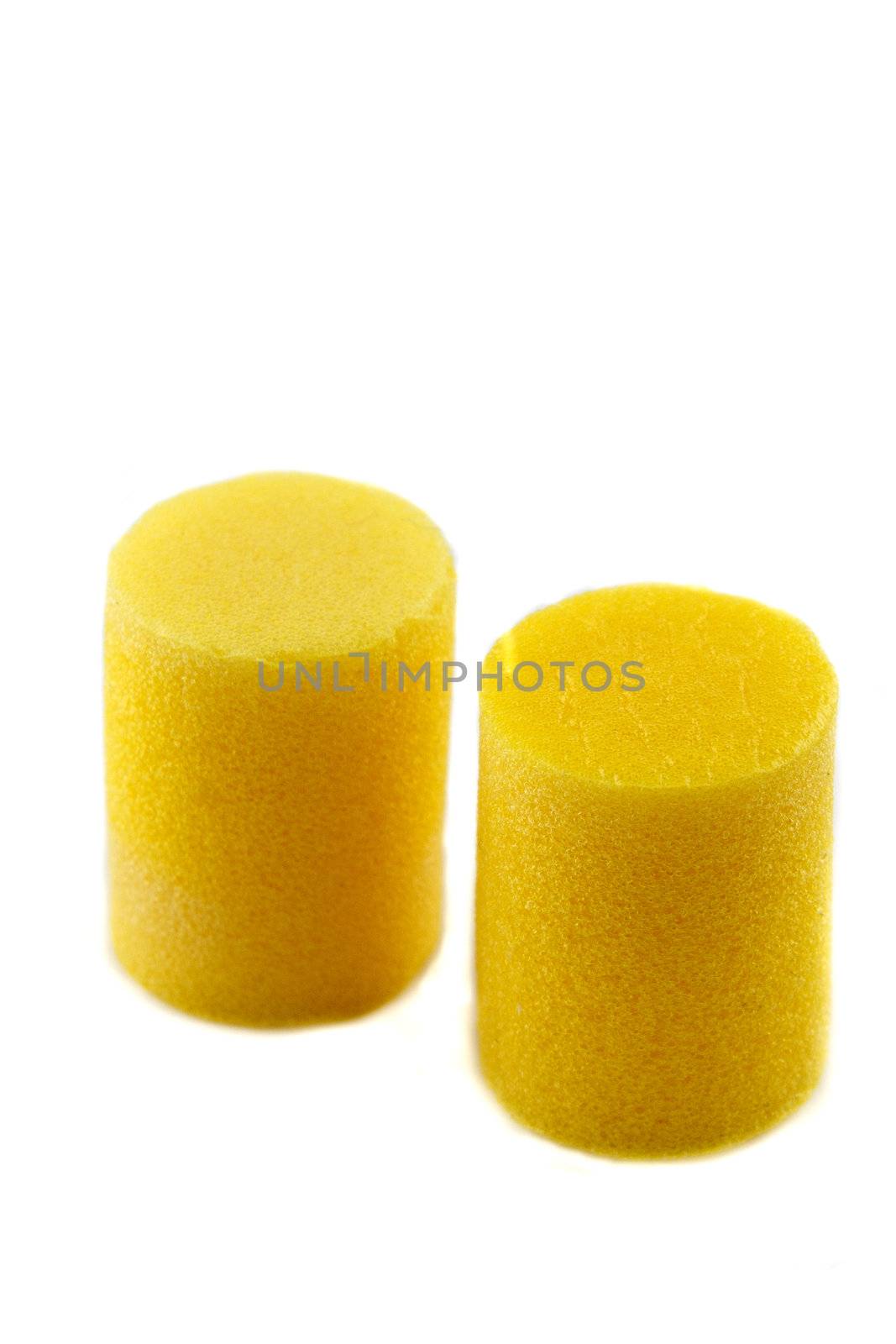 yellow ear plugs on a white background