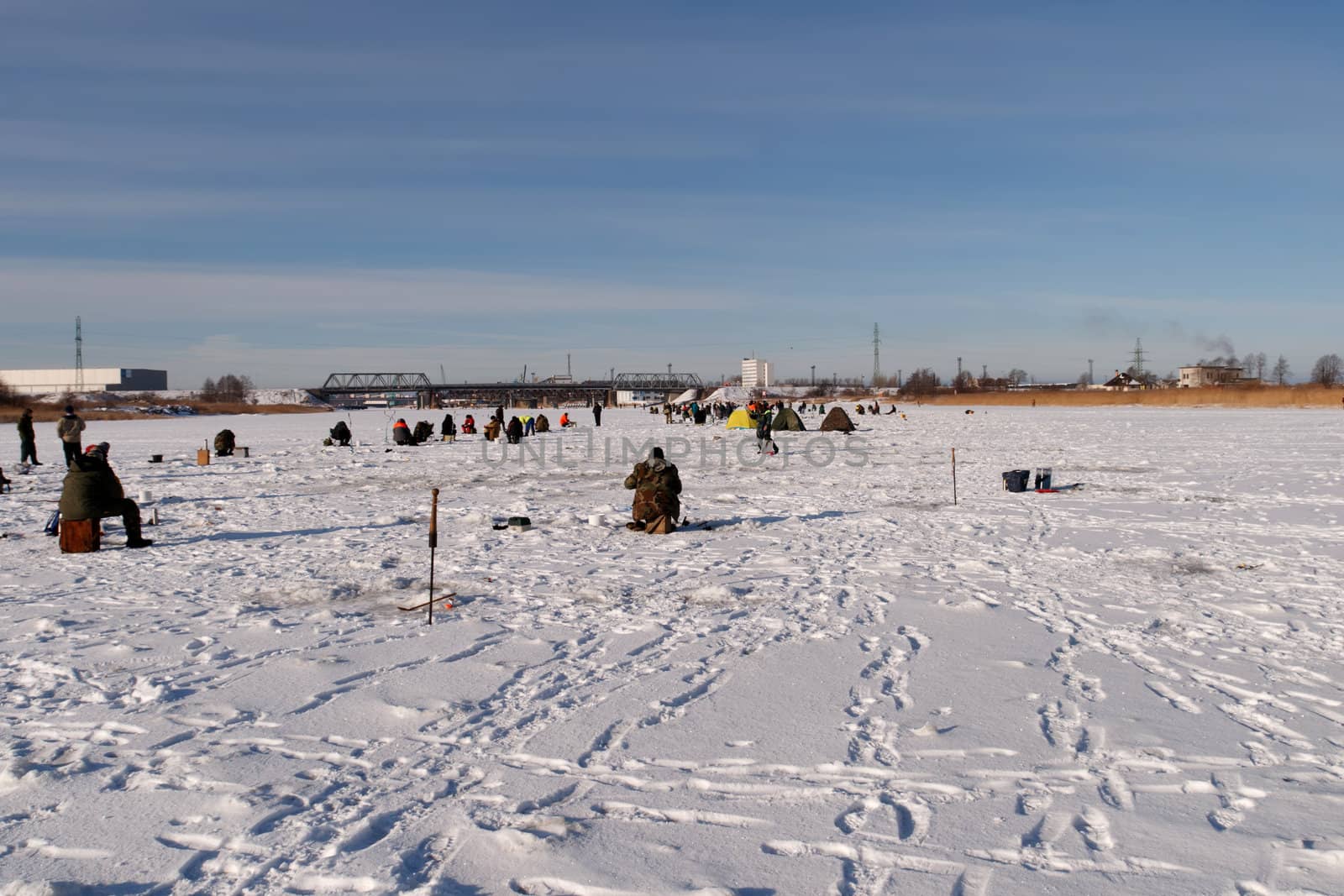 ice fishermens fishing on a frozen river