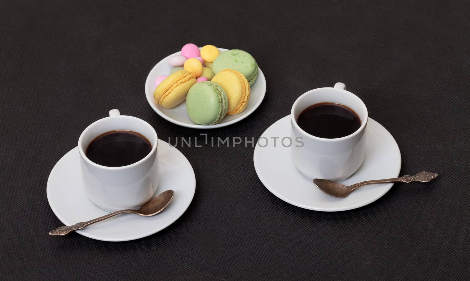 Two cups coffee and macaroon by Discovod