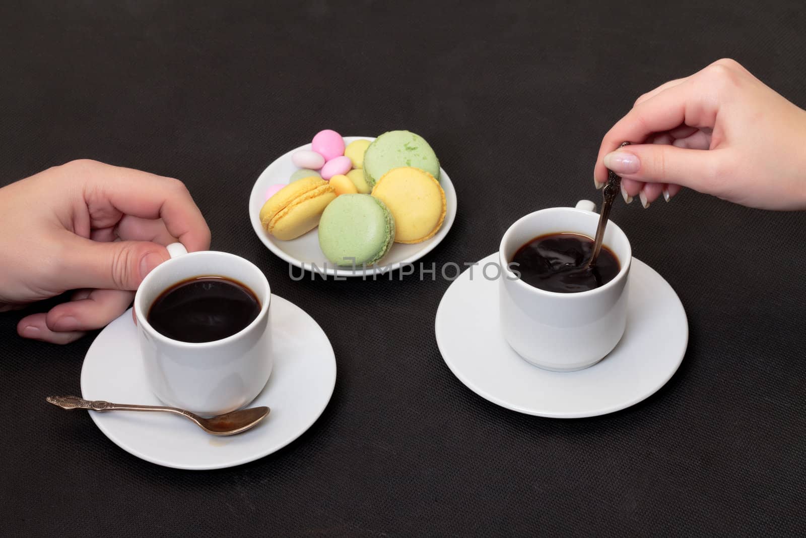 Couple drinking coffee with macaroon by Discovod