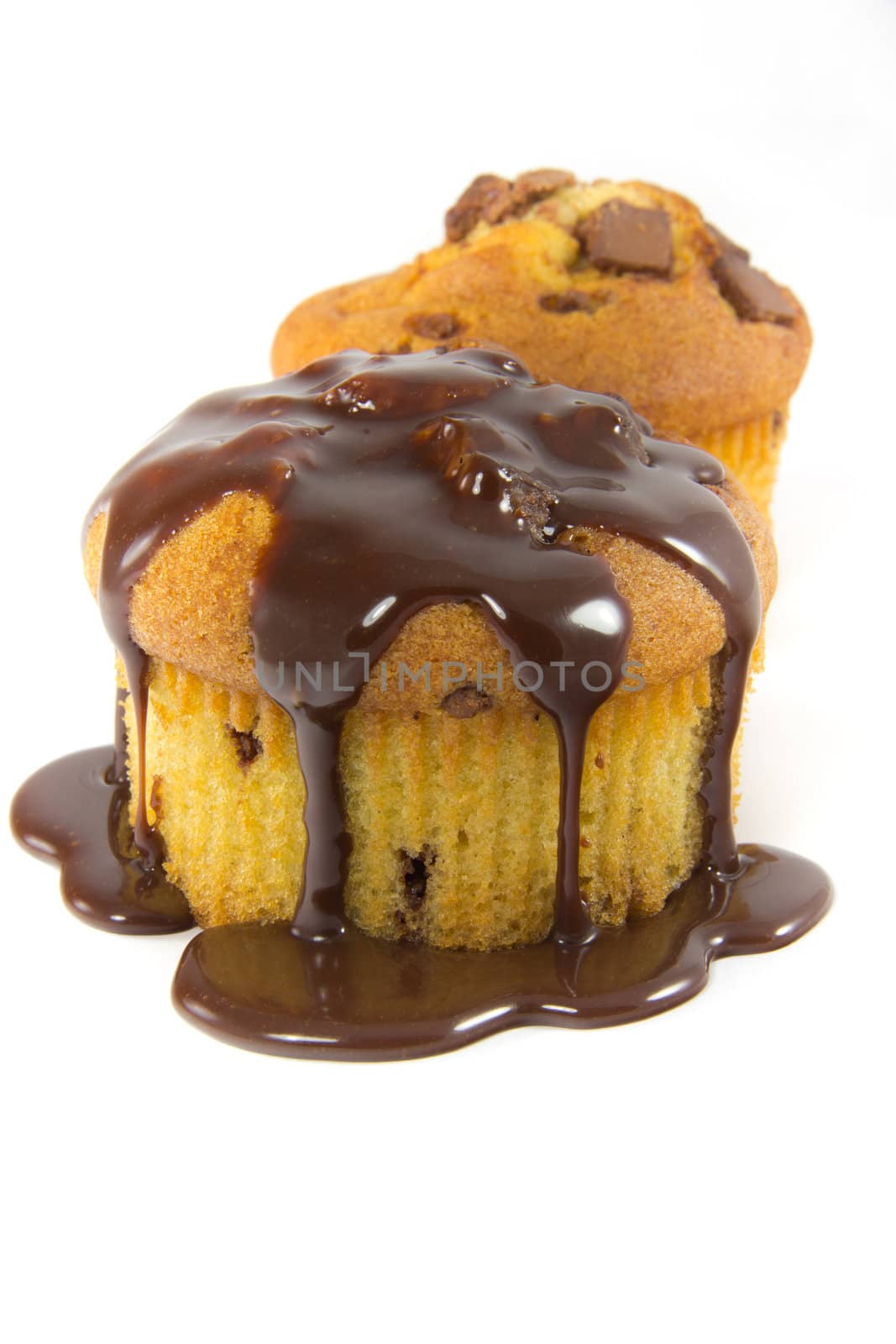 A picture of two muffins with melted chocolate toppings