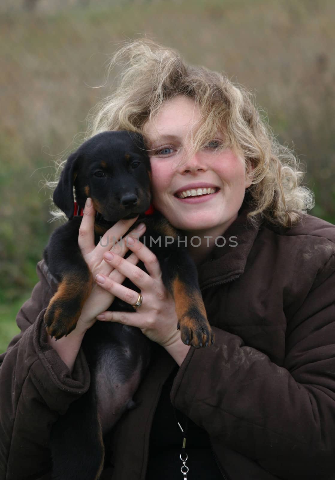young purebred french shepherd and blond woman