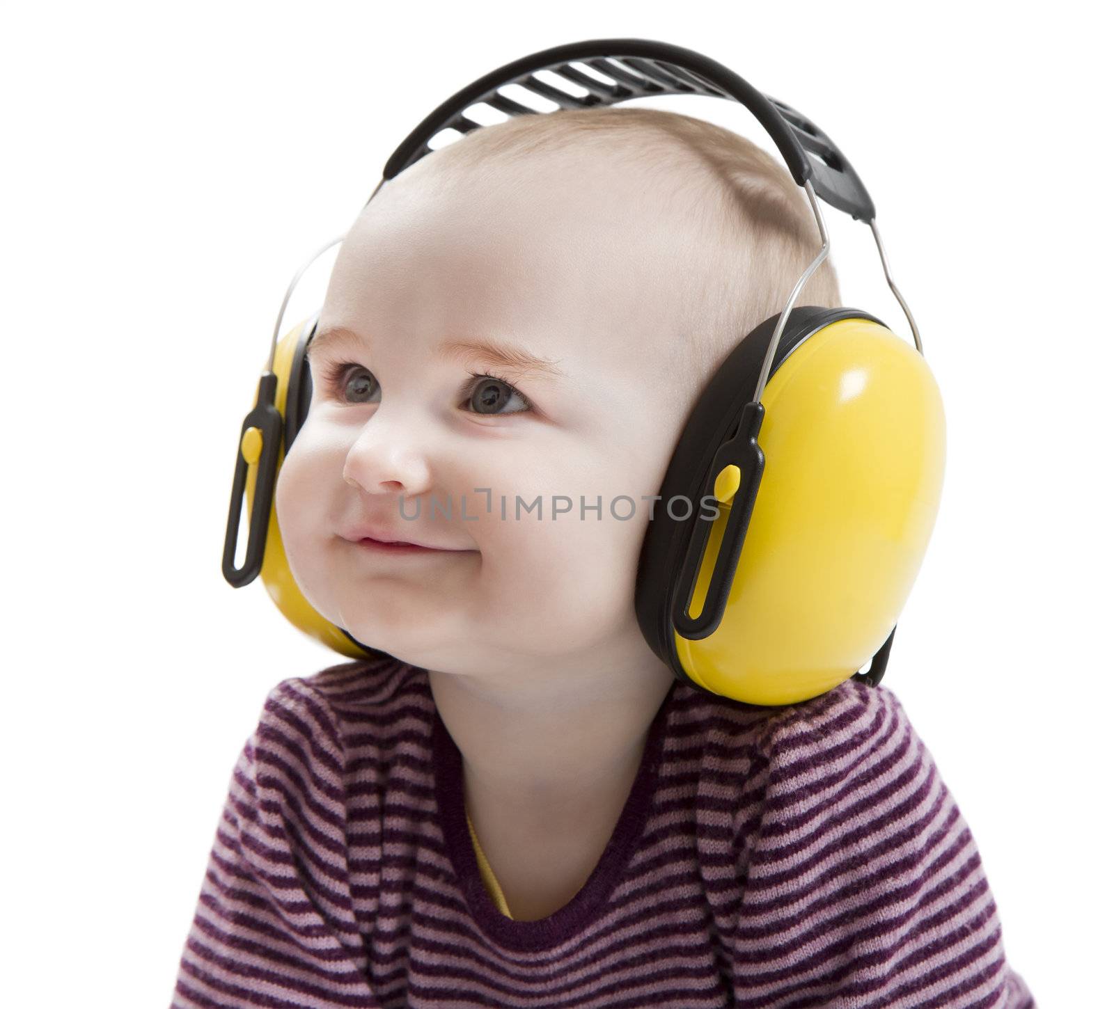young child with yellow ear protector in light background. satisfied
