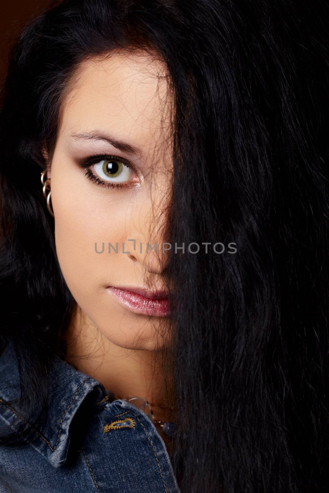 Young woman's face half-closed by hair