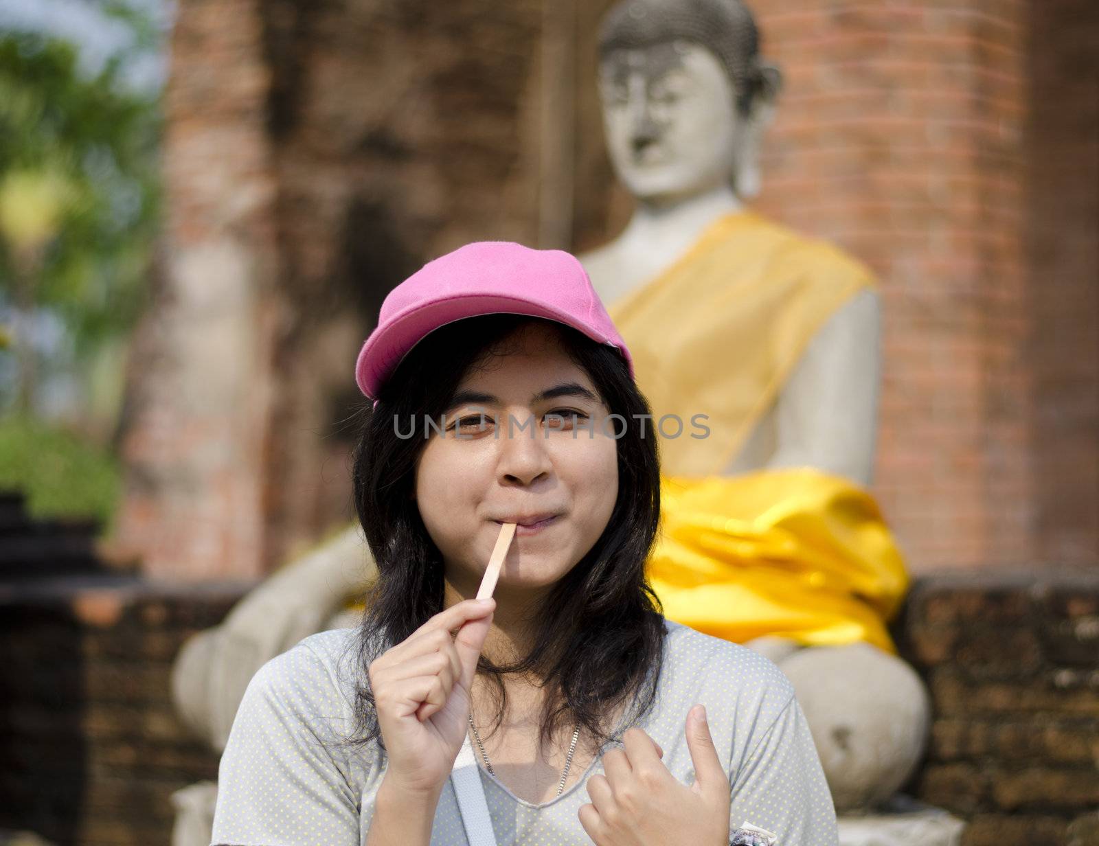Beautiful young girl and buddha at Wat Yai Chai Mongkol Temple. Ayutthaya - Thailand 