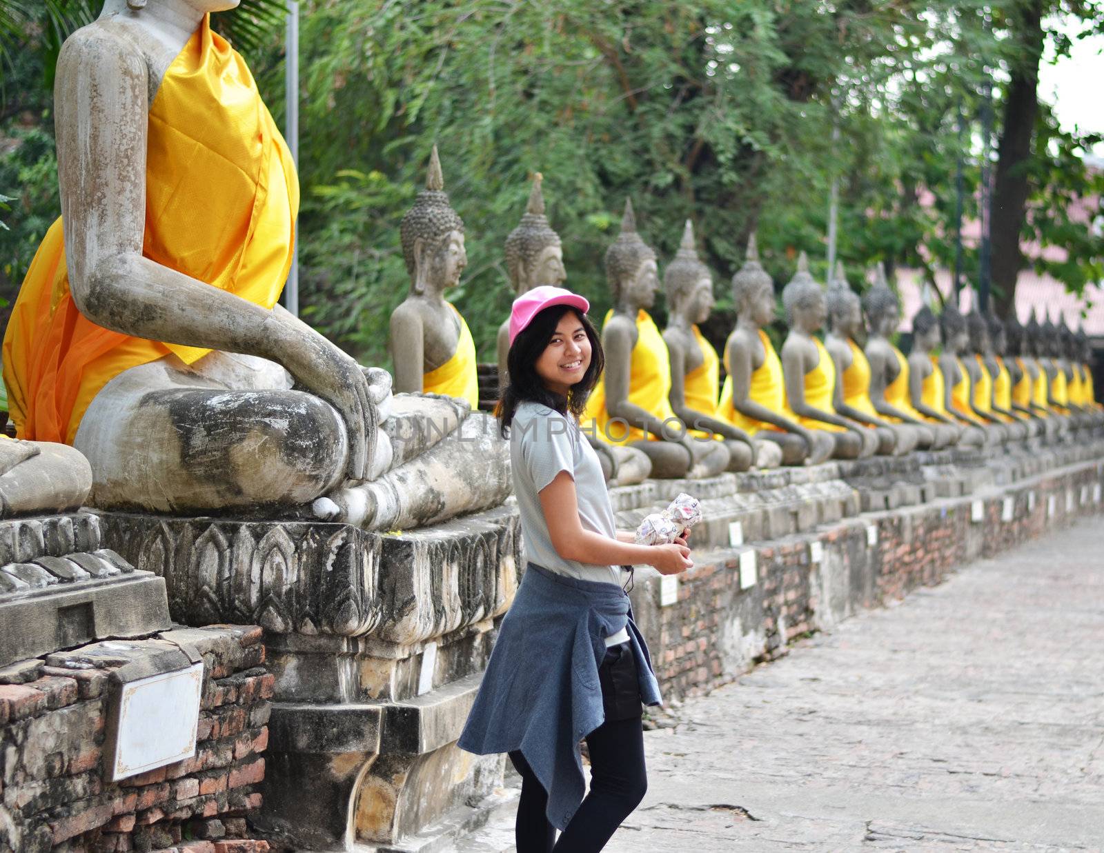 Beautiful asian woman and buddha at Wat Yai Chai Mongkol Temple by siraanamwong