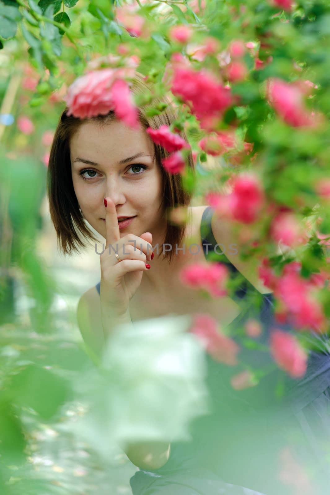 An image of a young beautiful woman amongst roses