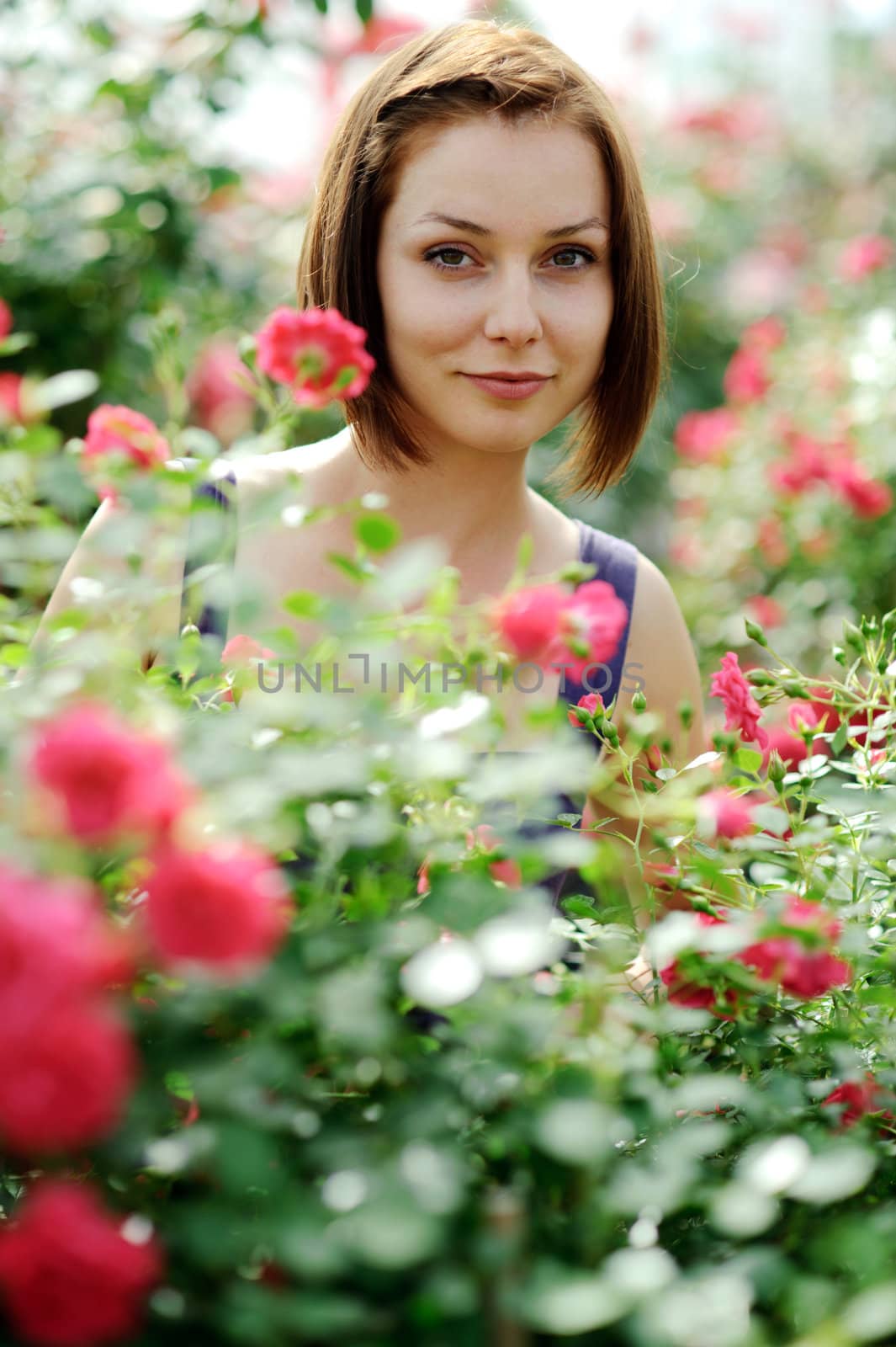 An image of a young beautiful woman and roses