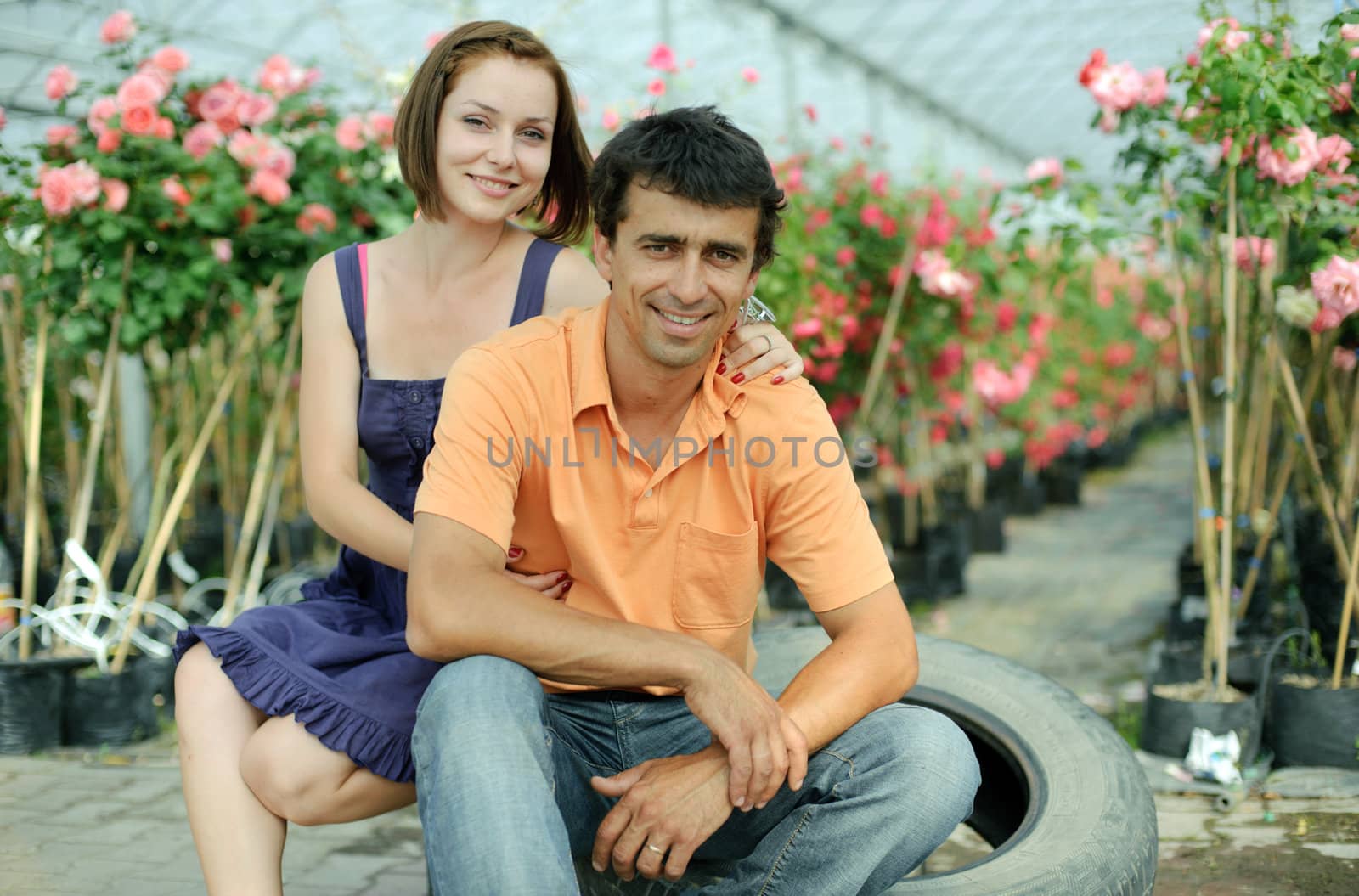 An image of a young couple in a greenhouse