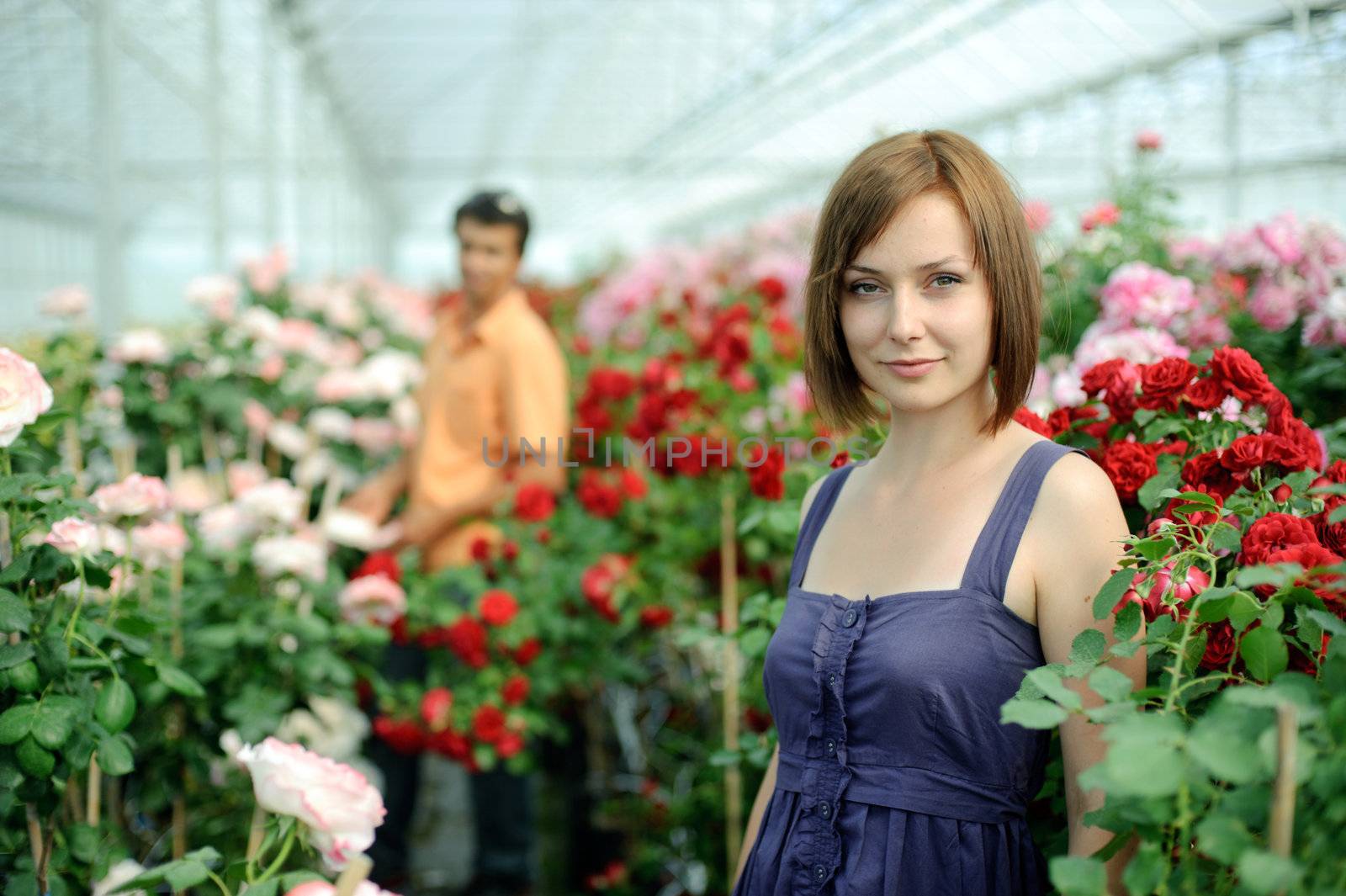 An image of a woman and a man in a greenhouse