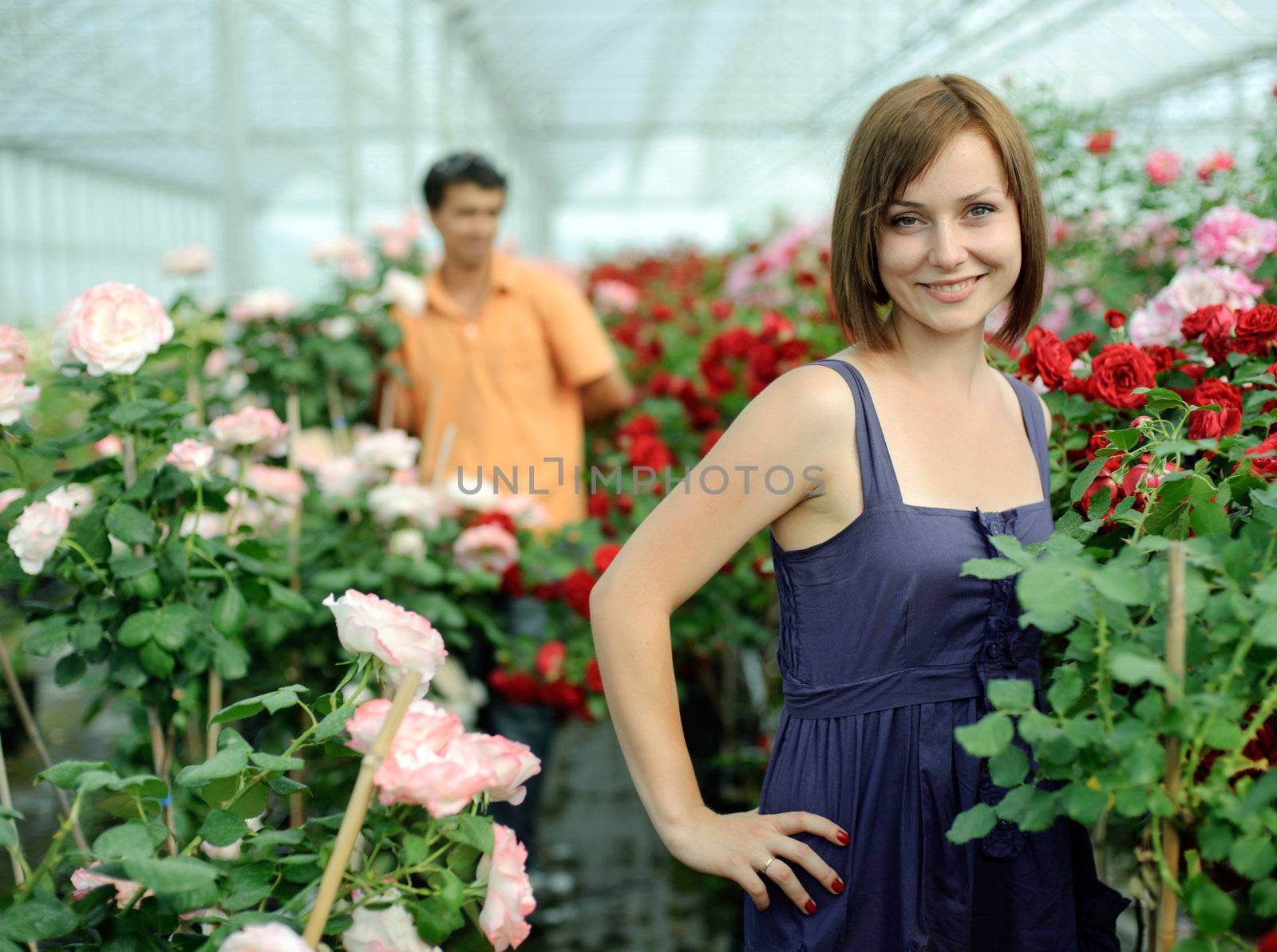 An image of a woman and a man in a greenhouse